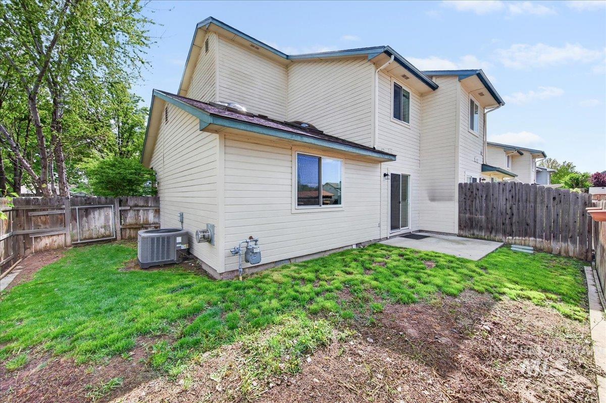 Back of property with a fenced backyard and a patio