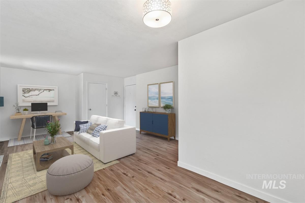 Living area featuring wood finished floors and a desk