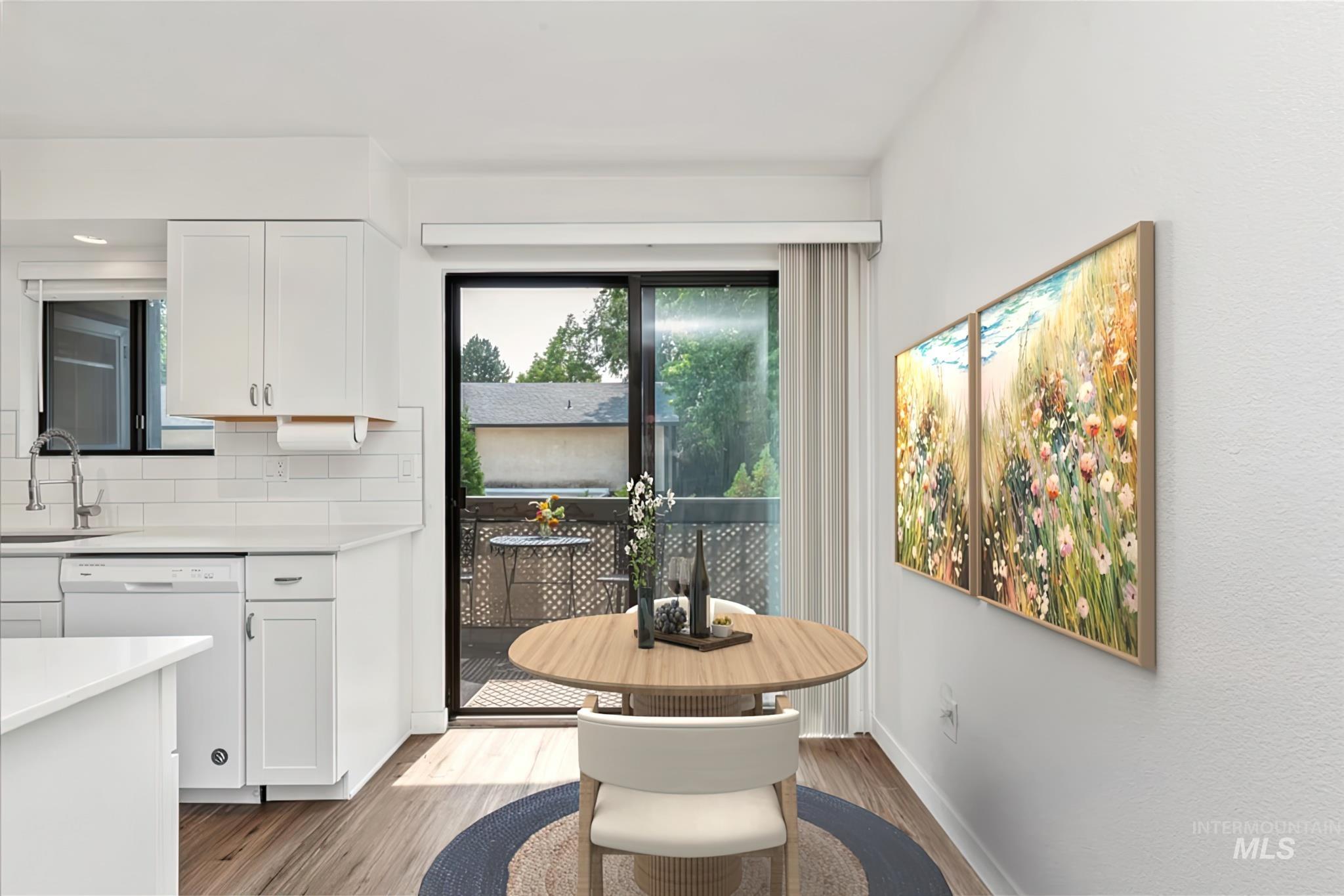 Dining area featuring light wood-style floors and baseboards
