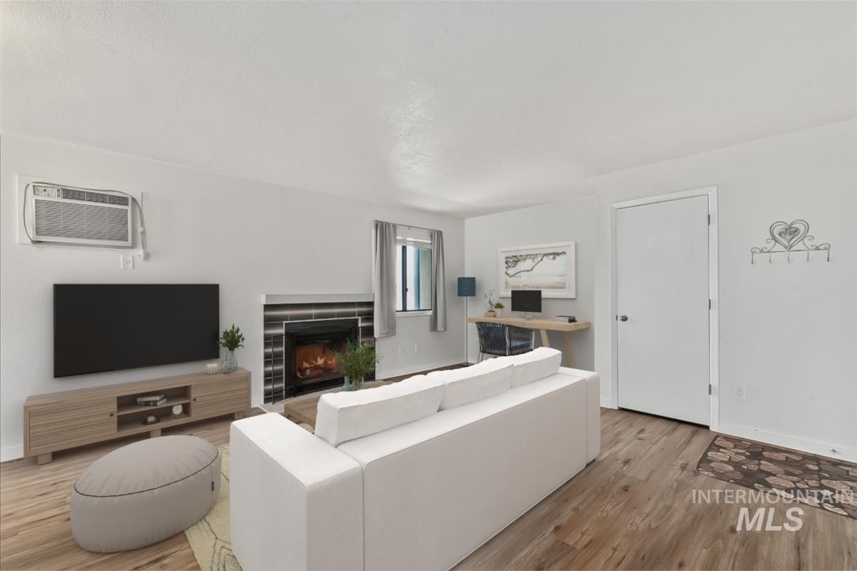 Living area featuring light wood finished floors and a fireplace