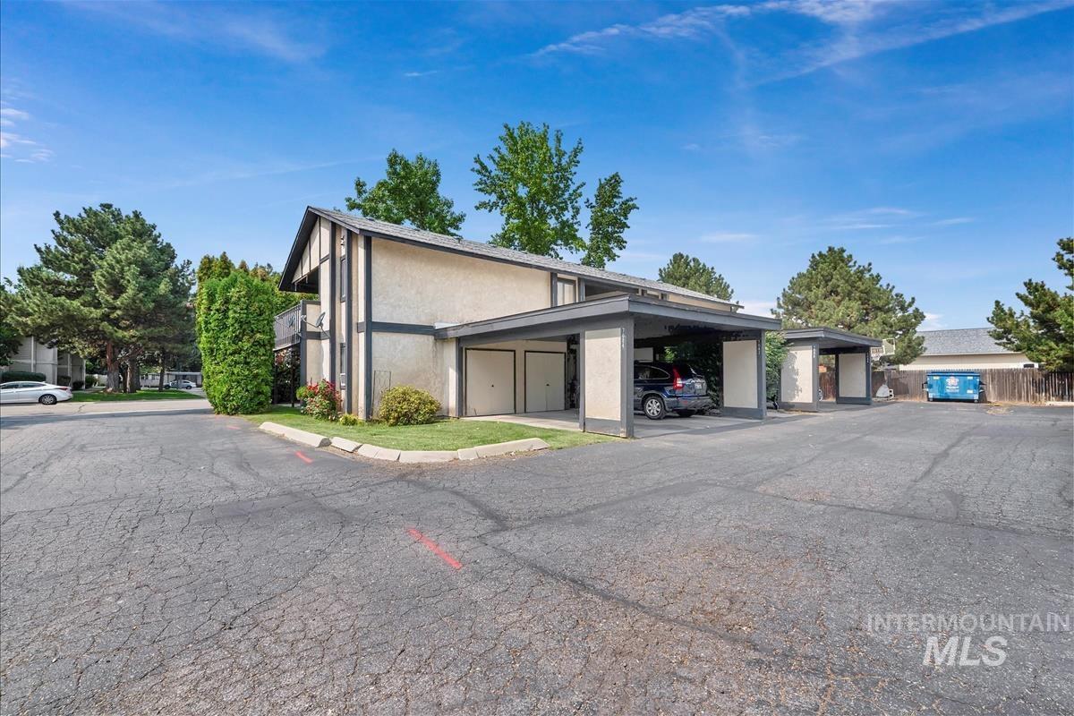 View of property featuring covered parking