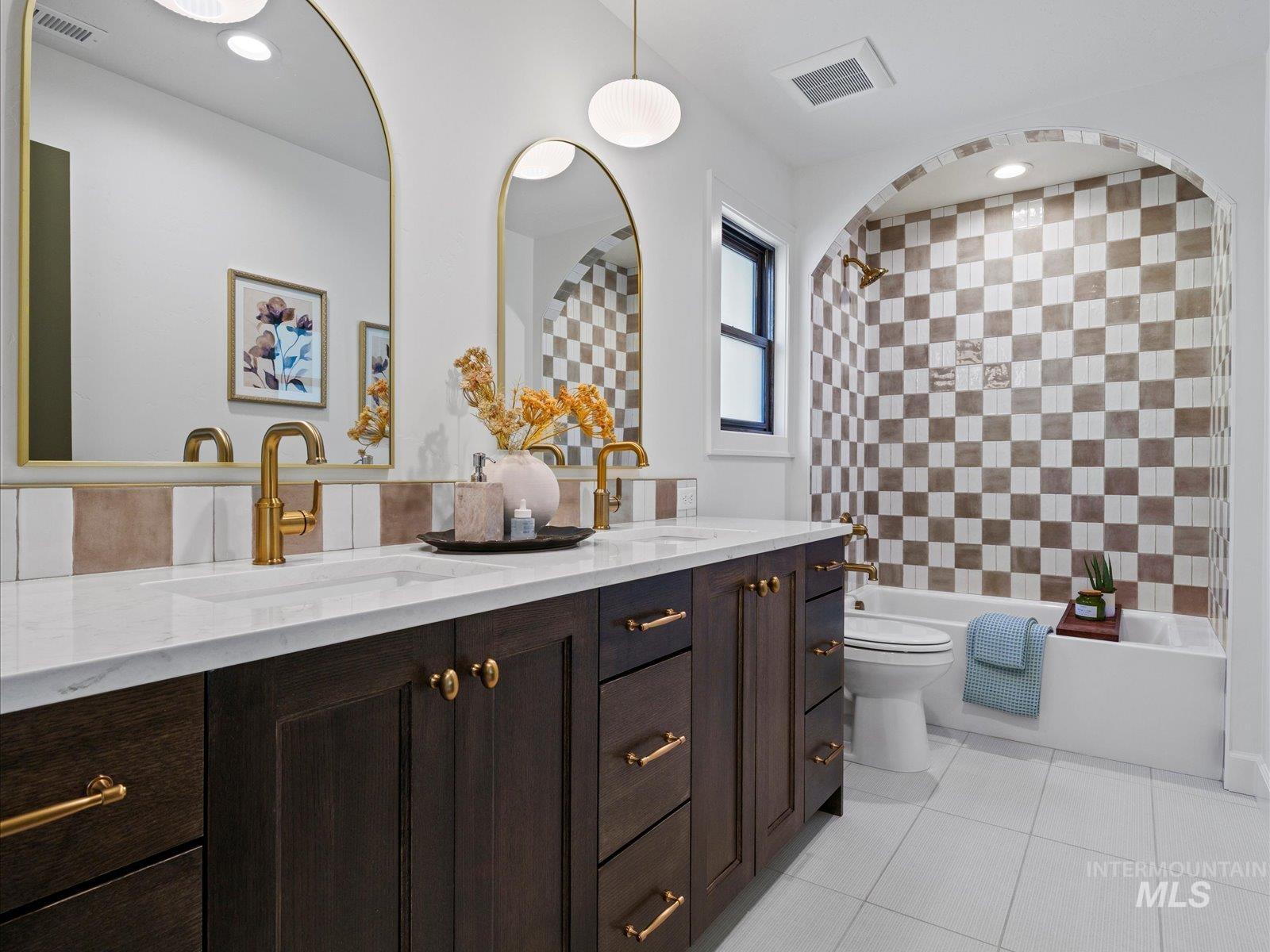 Full bath with double vanity, light tile patterned floors, tub / shower combination, and recessed lighting