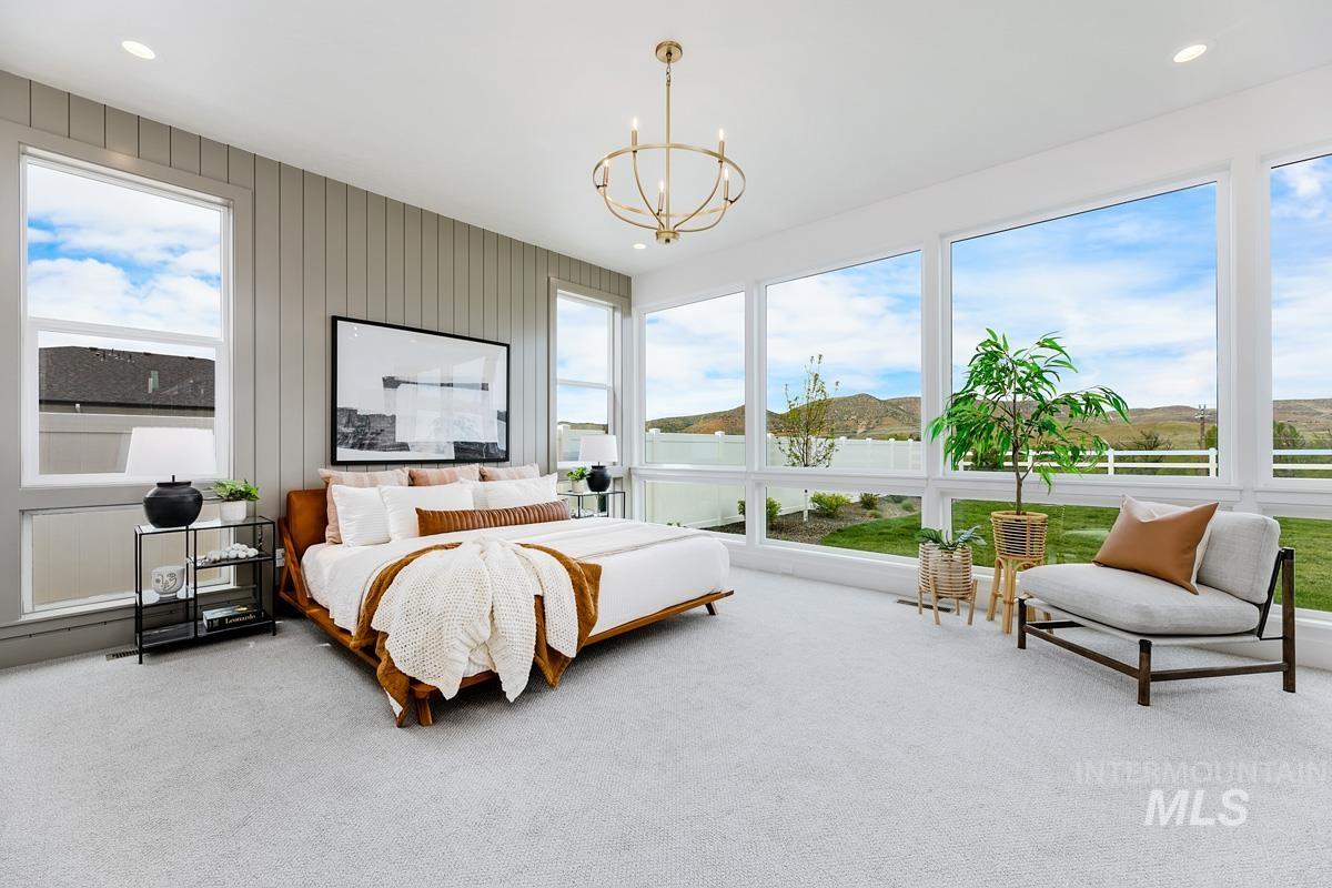 Bedroom with multiple windows, carpet flooring, a chandelier, and recessed lighting