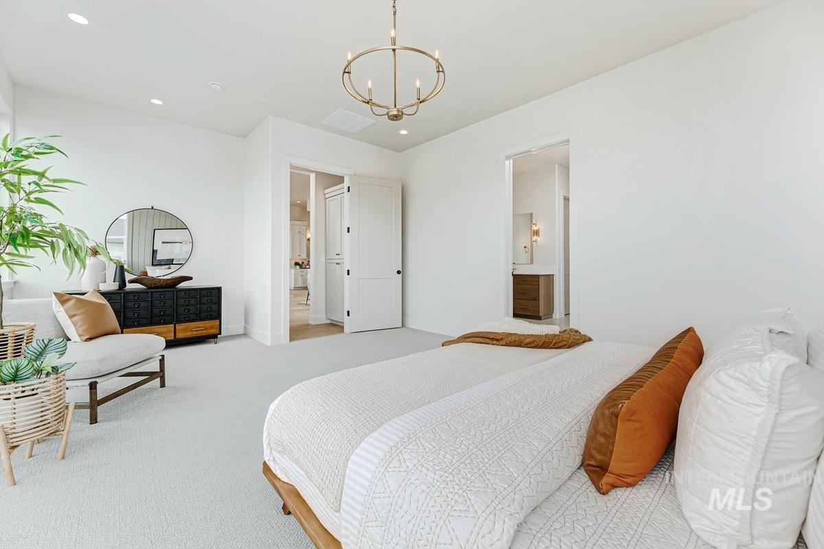 Bedroom featuring carpet, a chandelier, recessed lighting, and ensuite bath