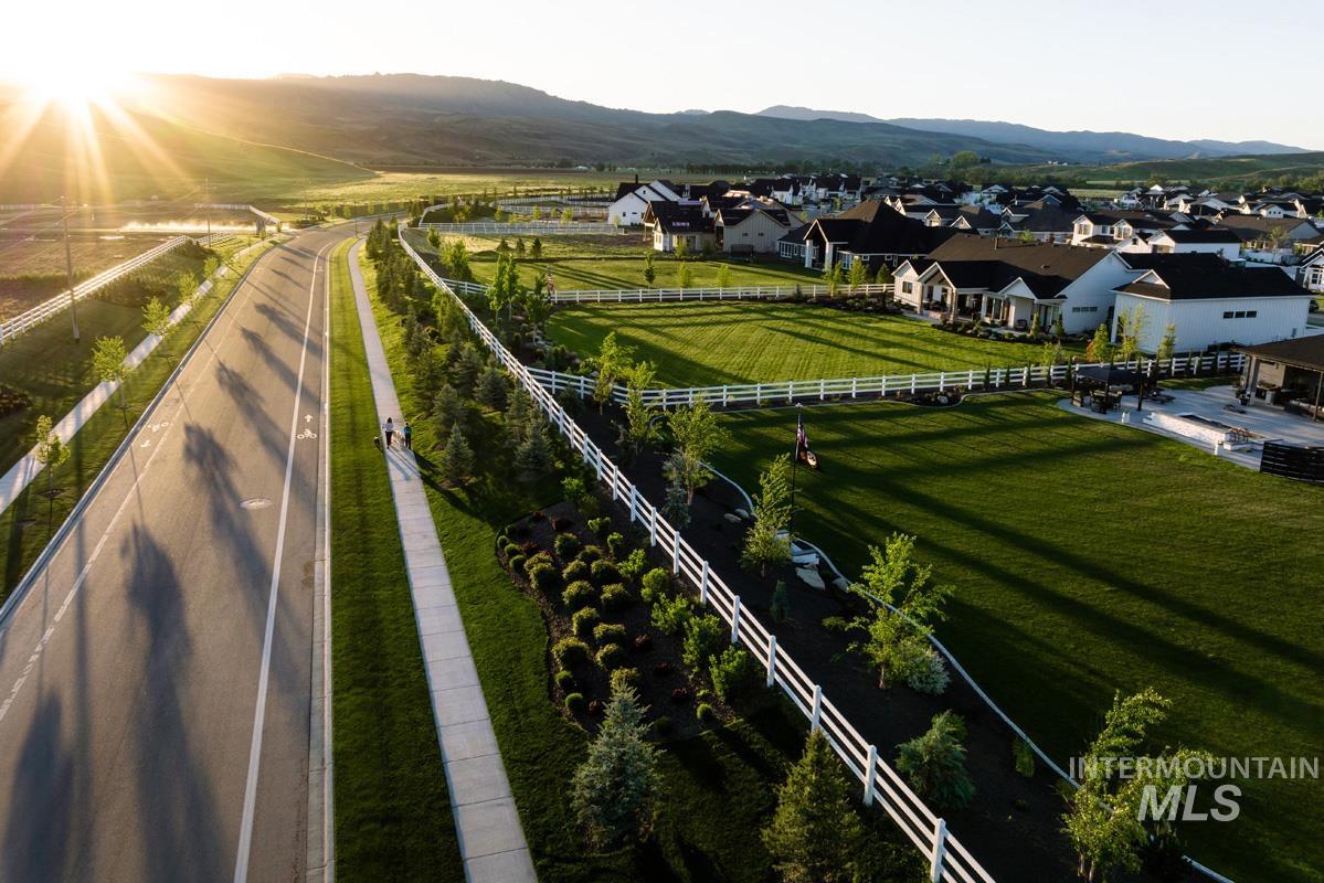 Overview of rural landscape featuring a mountain backdrop and nearby suburban area