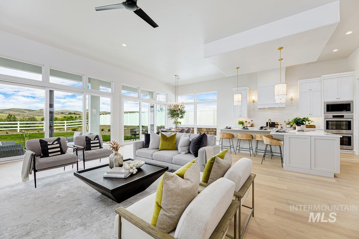 Living room featuring light wood finished floors, recessed lighting, and ceiling fan