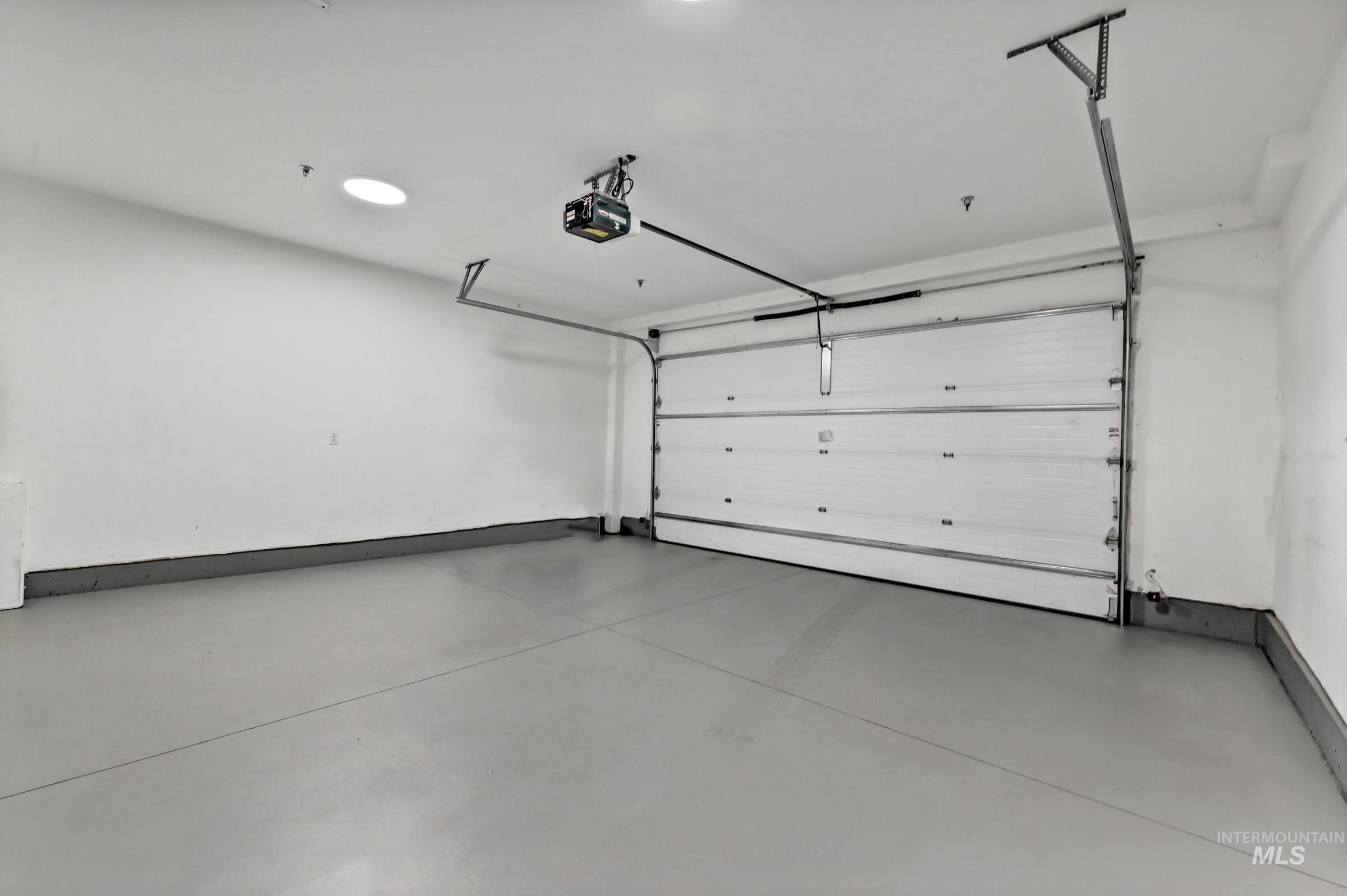 Two-car garage with open floor space and storage potential. Clean and well-maintained.