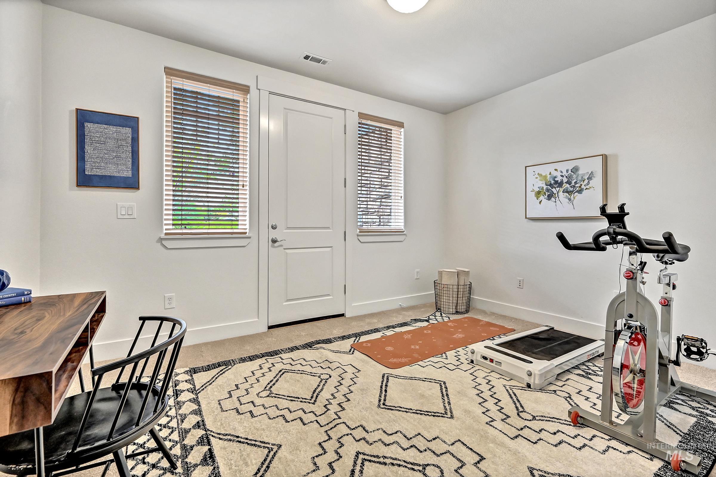 Ground-level bedroom with separate entrance/exit to the patio. Flexible space for guests or home office.