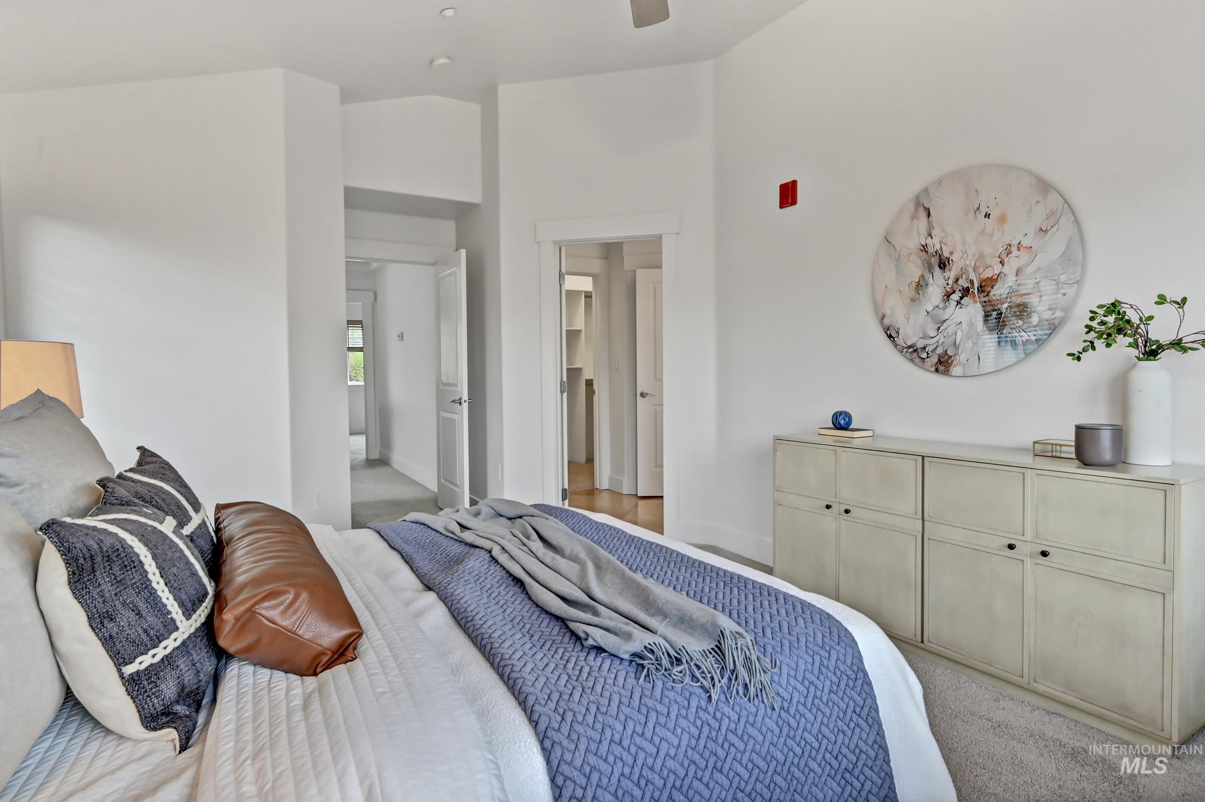 Primary bedroom with light-colored carpet and natural light. Comfortable retreat with neutral finishes.