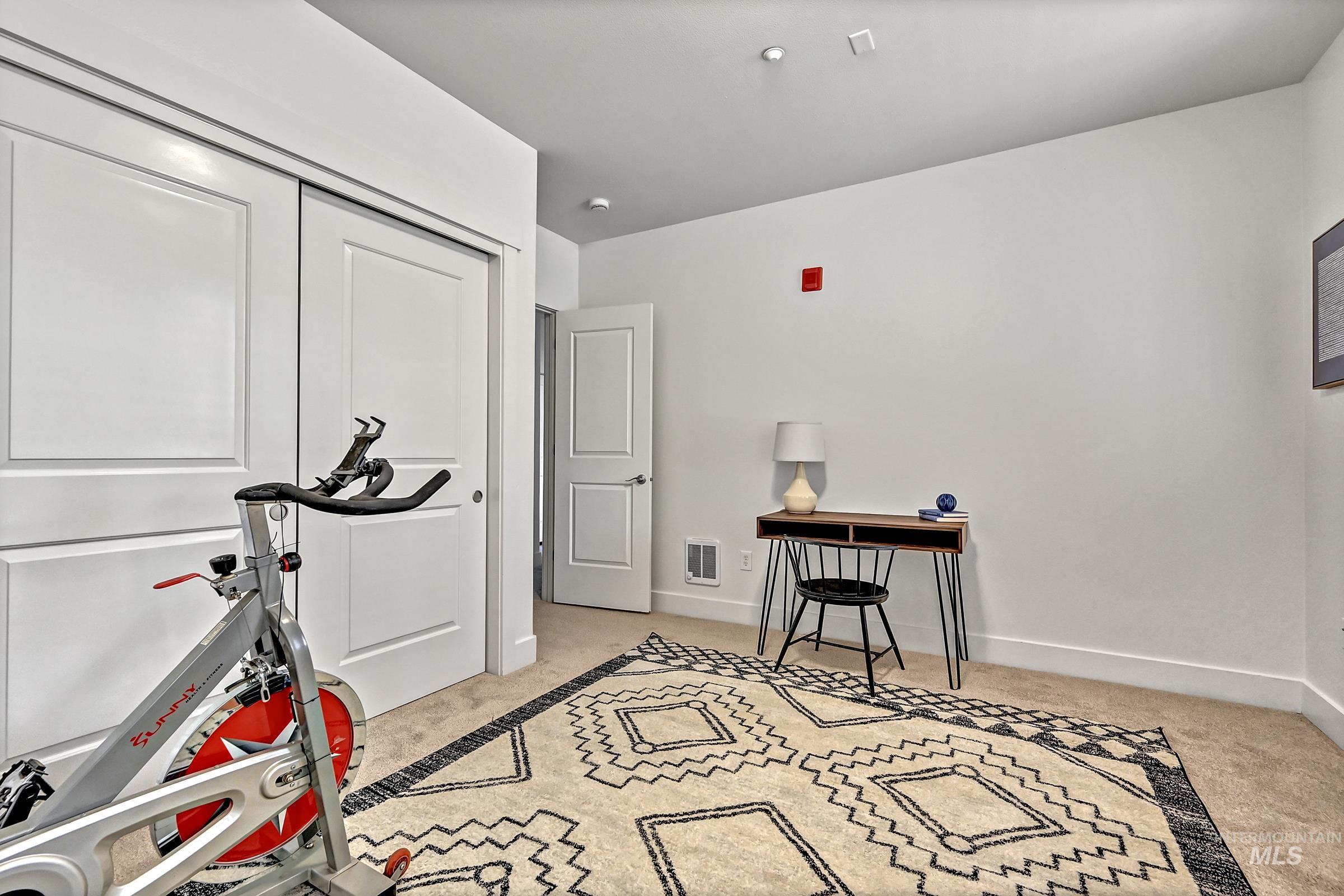 Ground-level bedroom with separate entrance/exit to the patio. Flexible space for guests or home office.