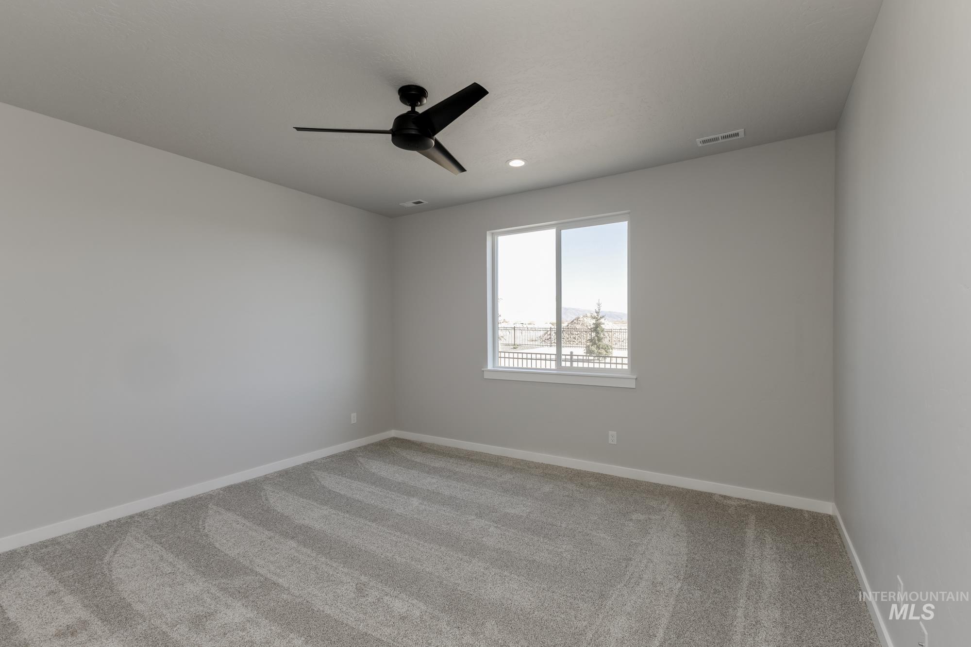 Unfurnished room featuring light colored carpet, a ceiling fan, and recessed lighting
