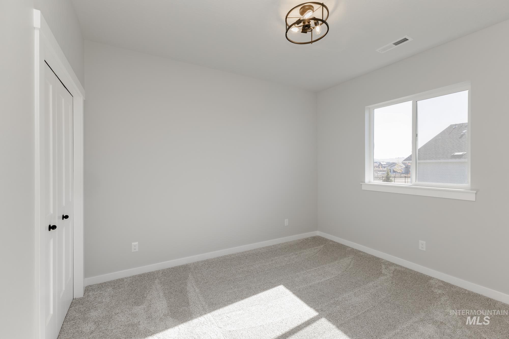 Unfurnished bedroom featuring carpet and a closet