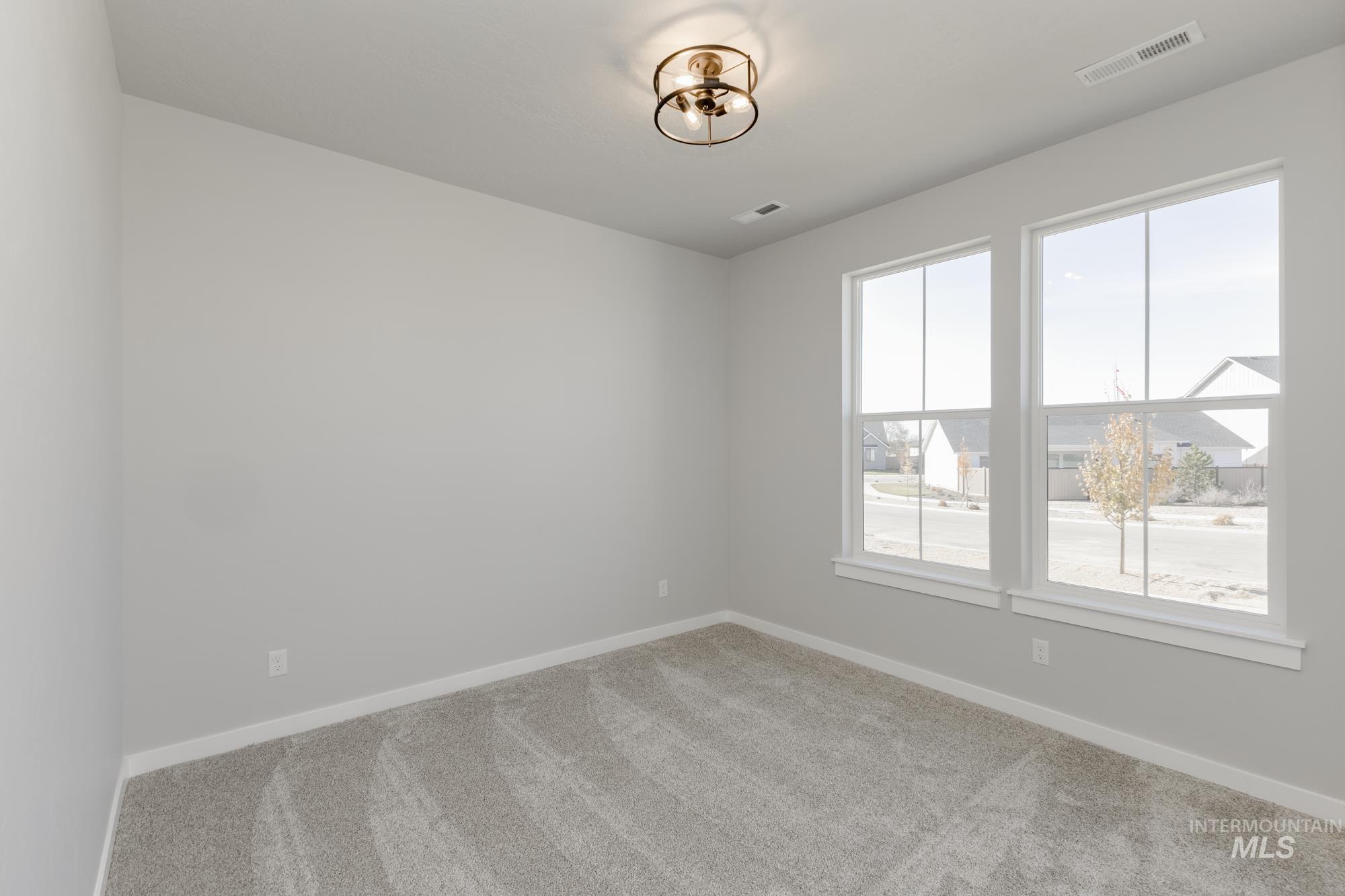 Spare room with baseboards and carpet floors