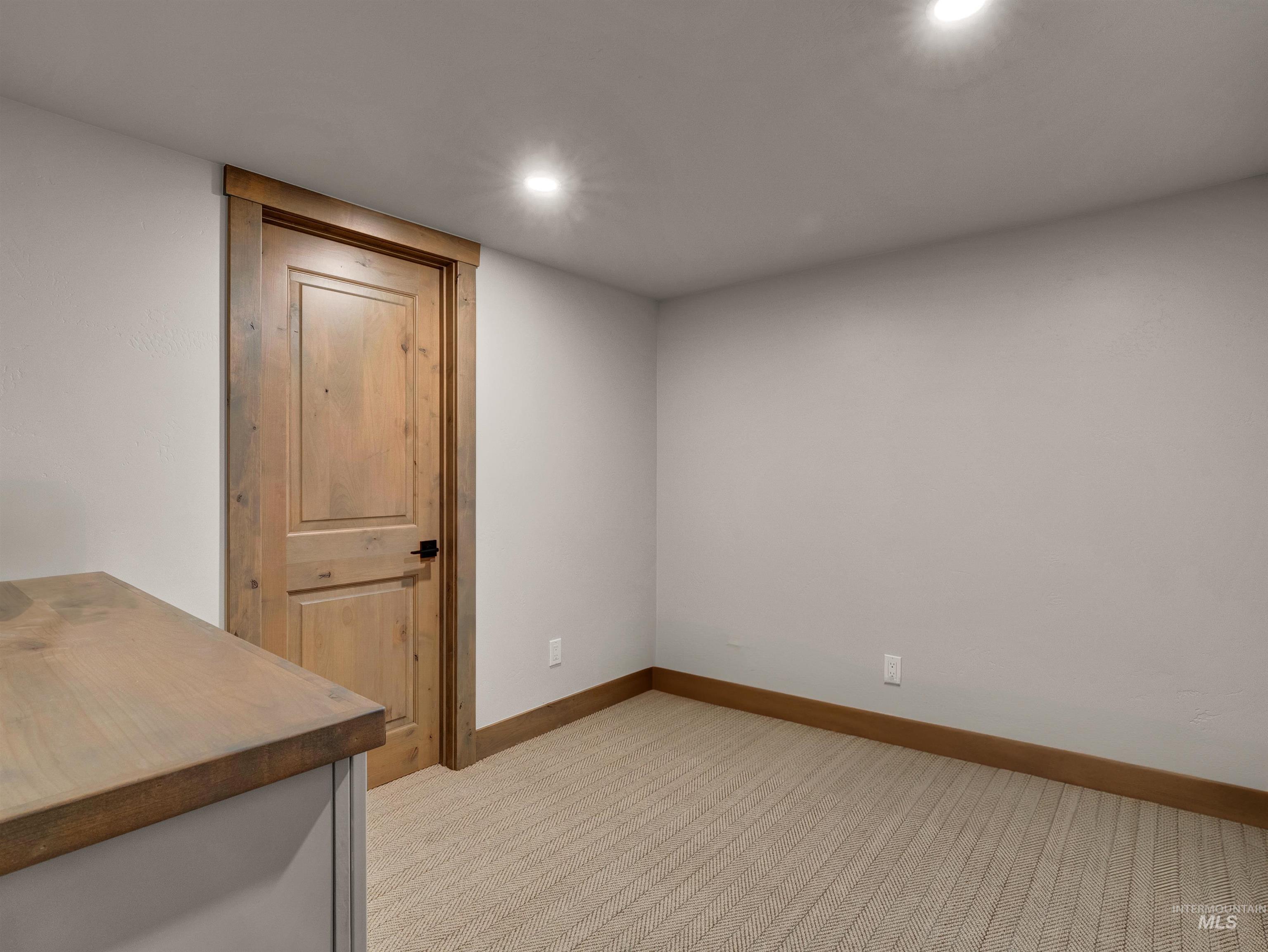 Spare room with light colored carpet and recessed lighting