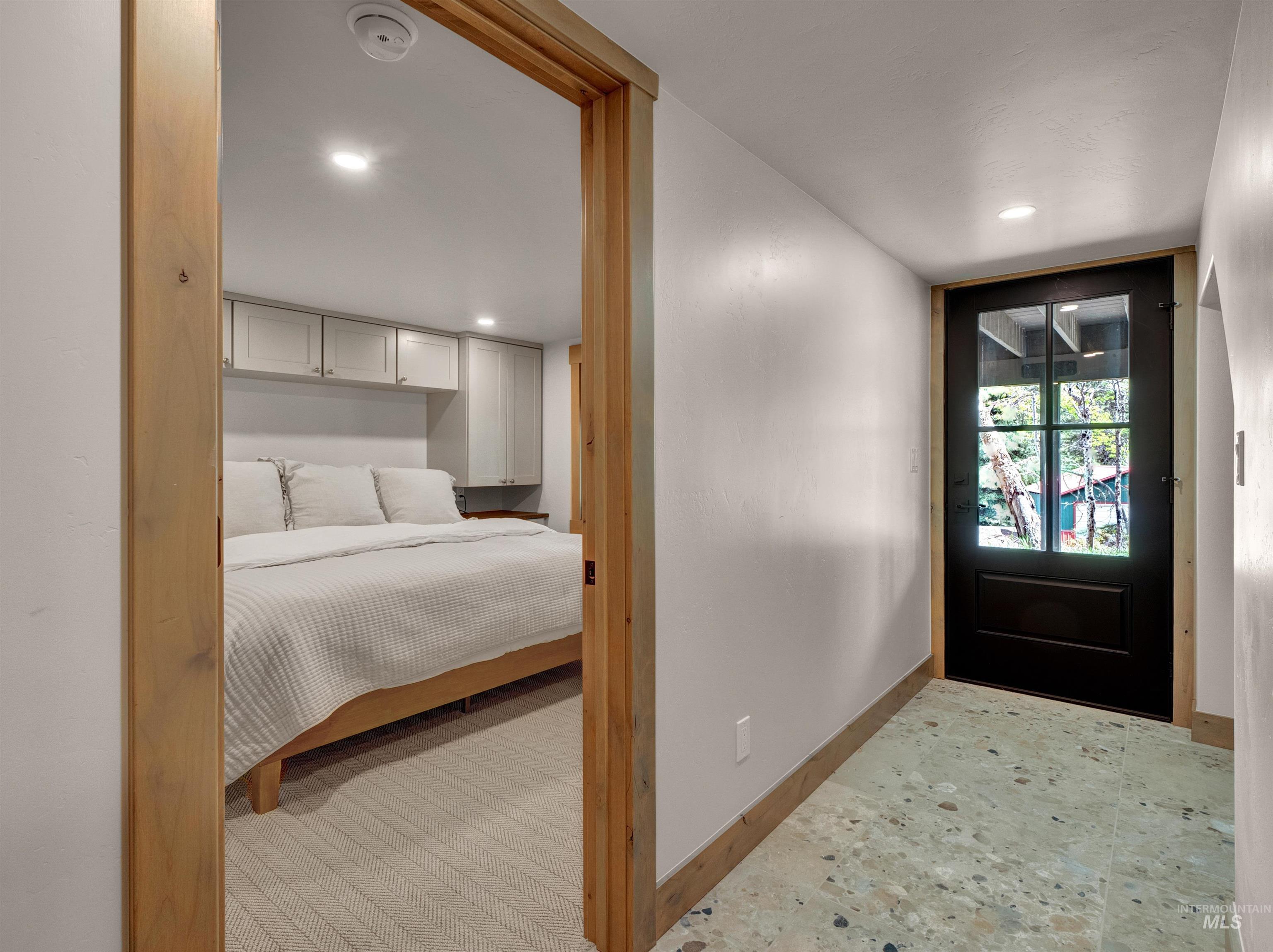 Foyer with baseboards and recessed lighting
