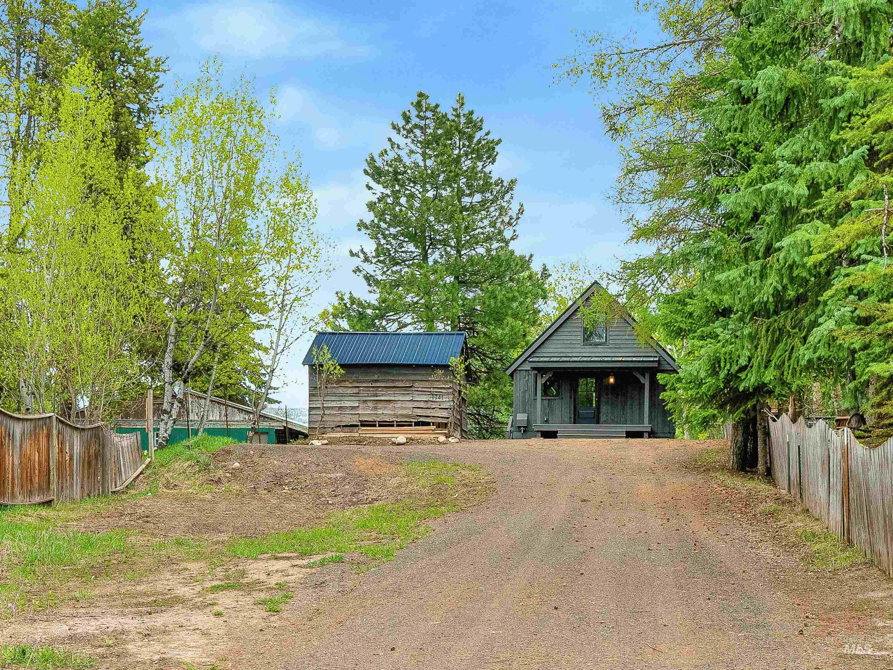 View of front of property featuring covered porch and driveway
