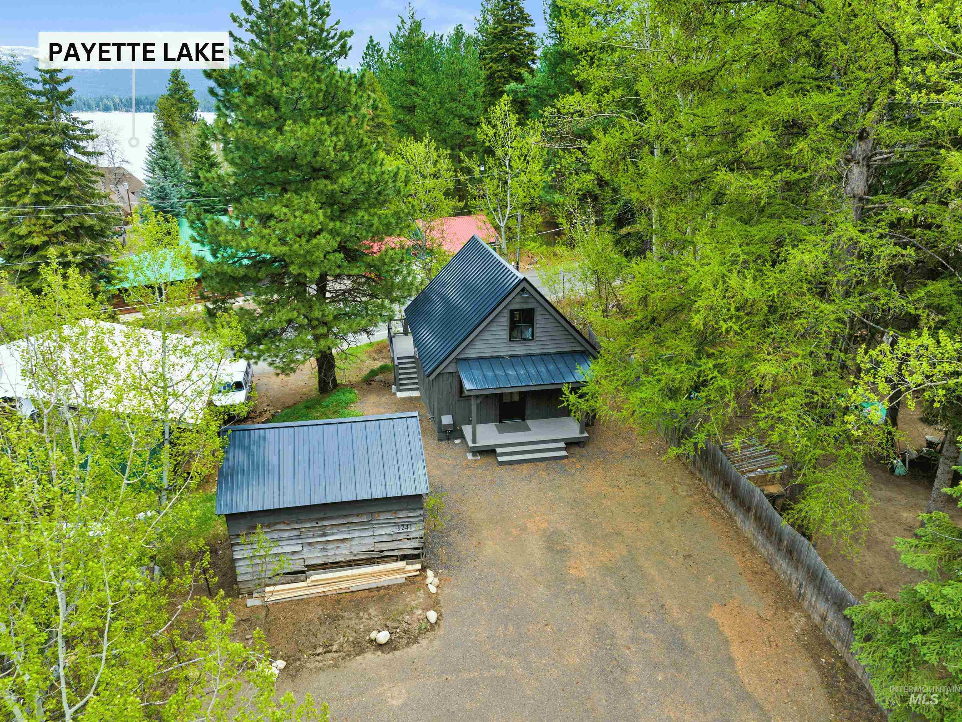 View from above of property featuring a tree filled landscape