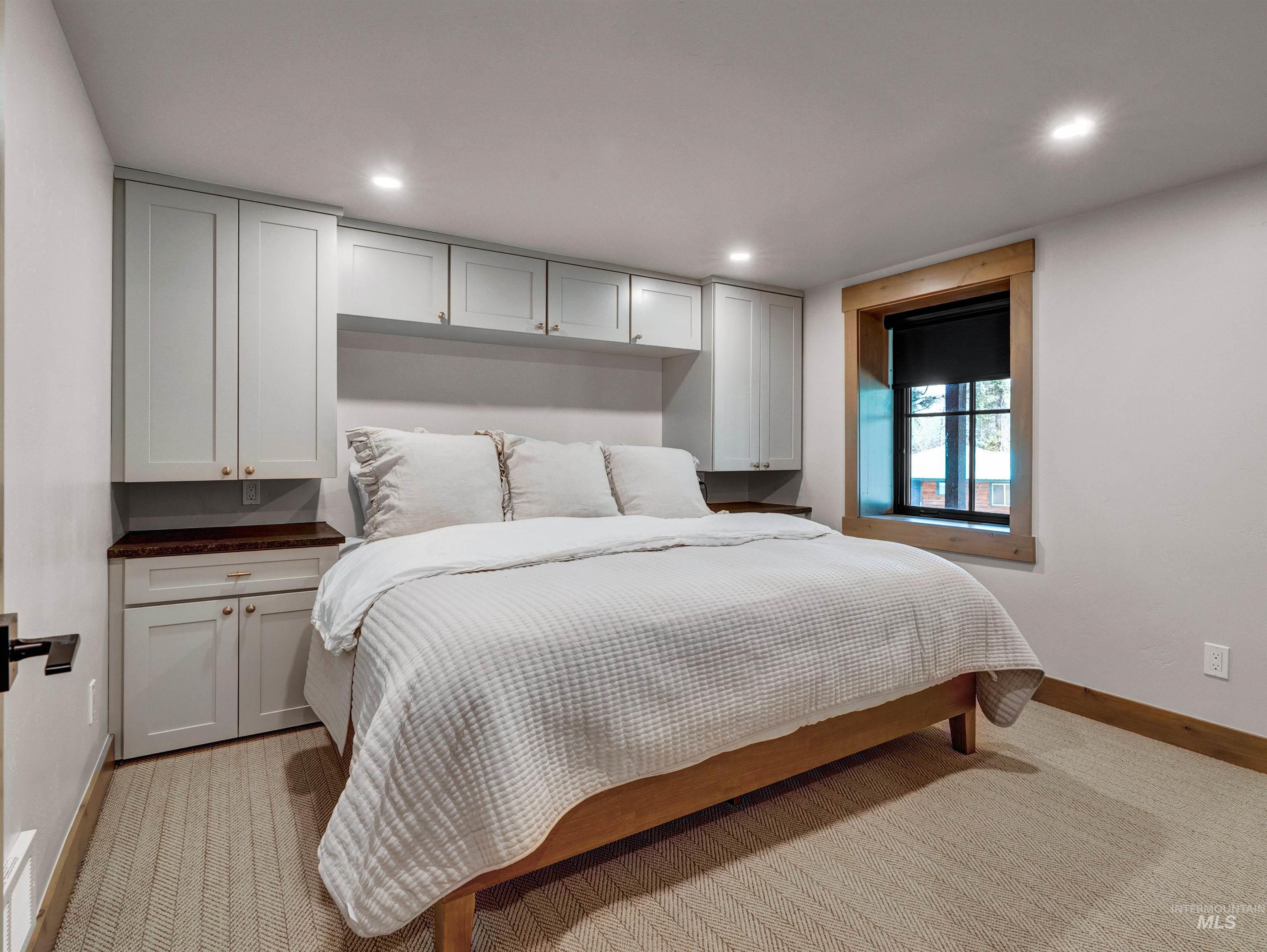 Bedroom featuring light carpet and recessed lighting