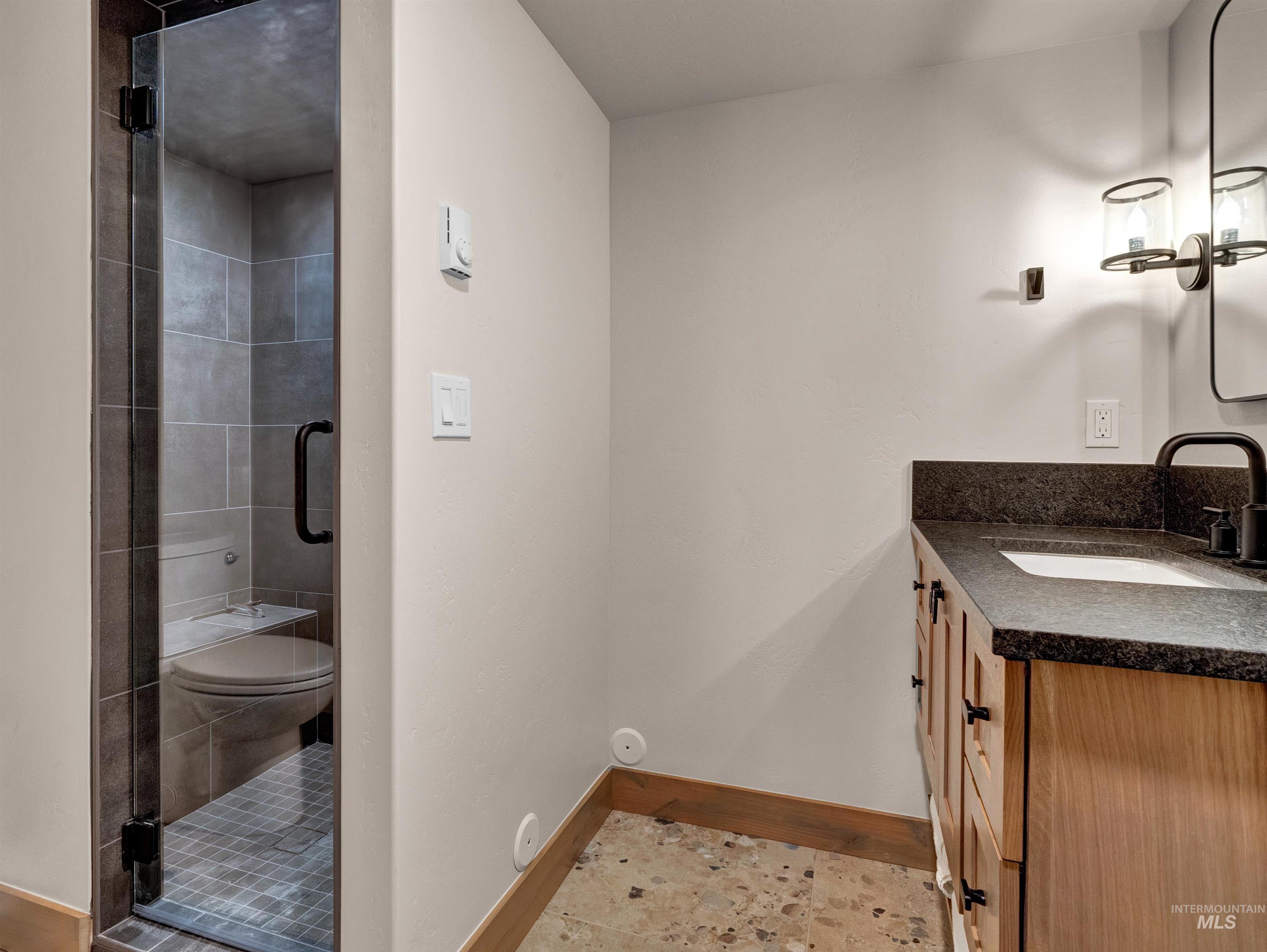 Full bath with vanity and a stall shower