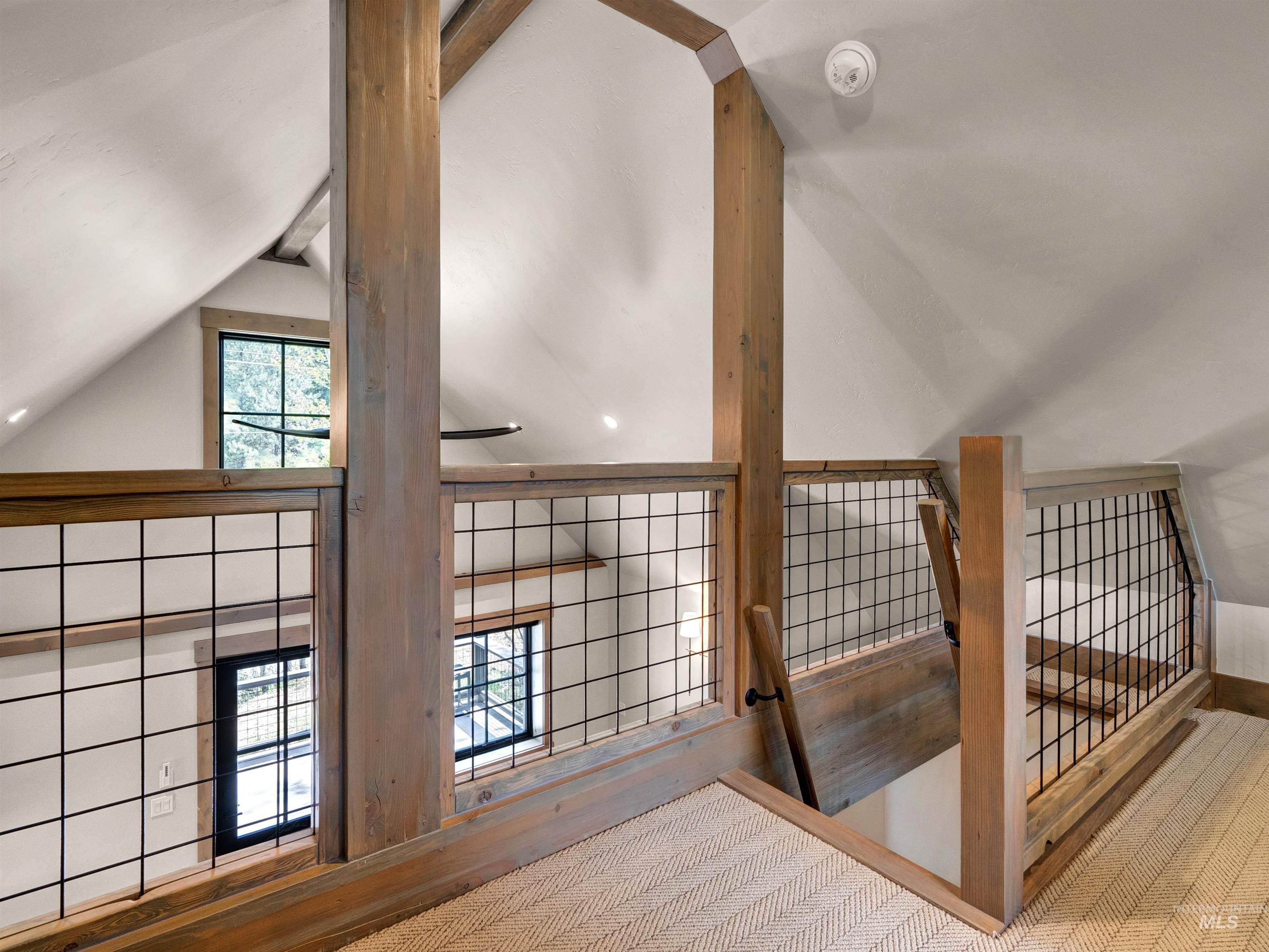 Corridor with lofted ceiling with beams