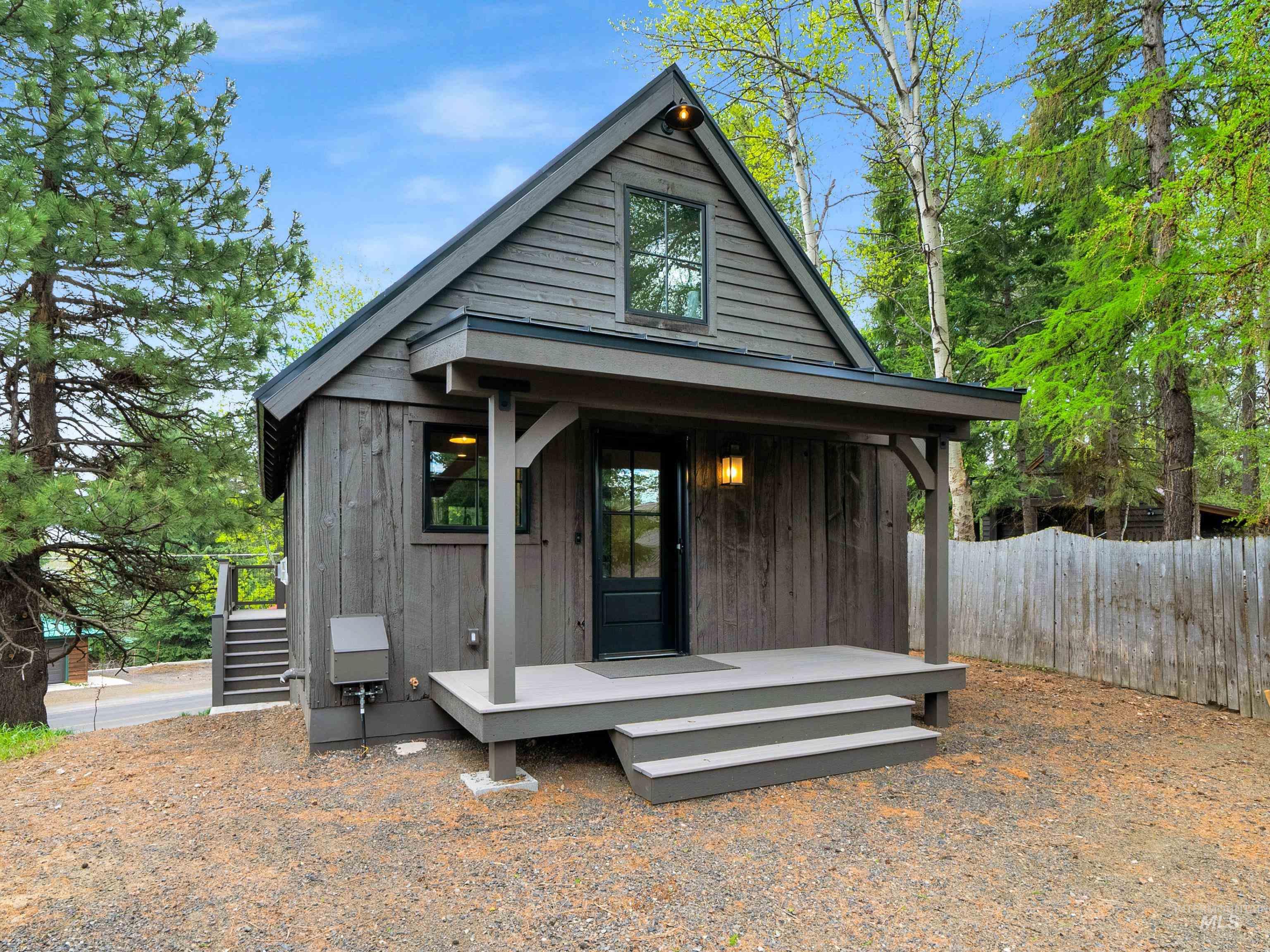 Back of house featuring board and batten siding and covered porch