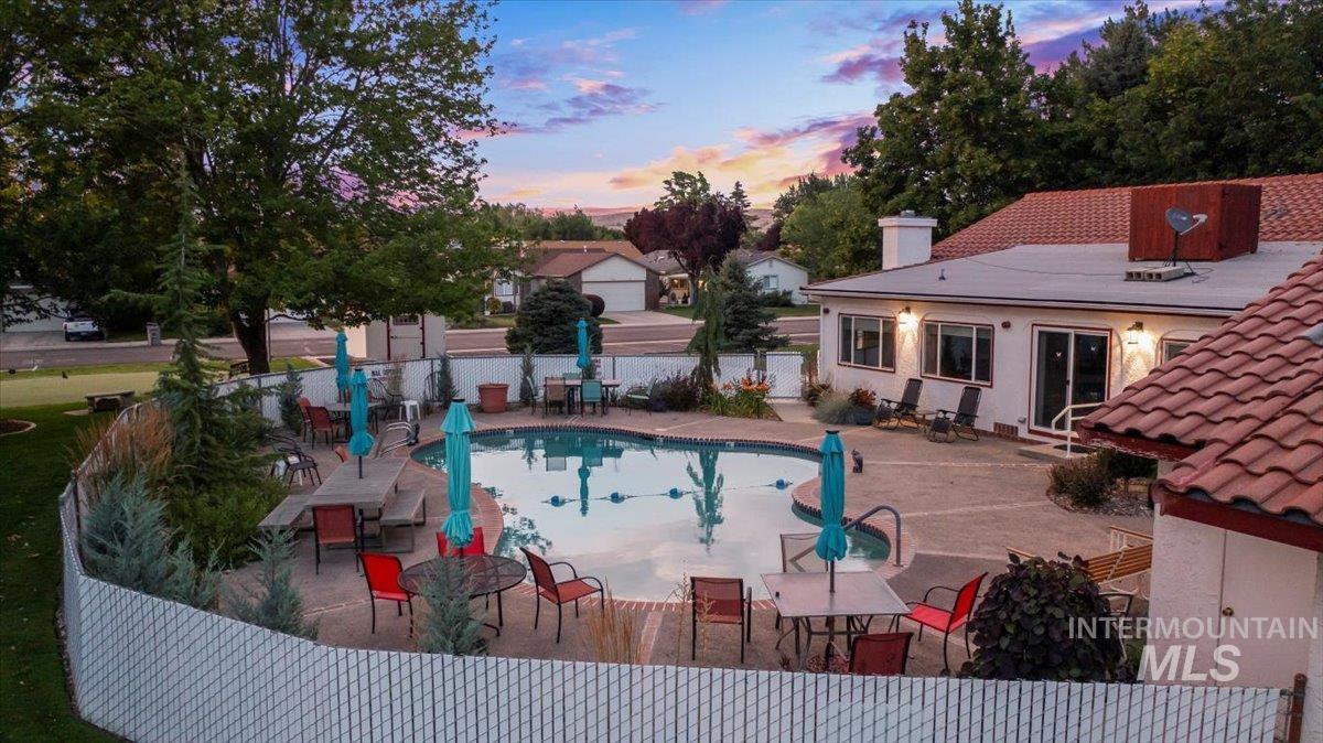 Pool at dusk with a patio area