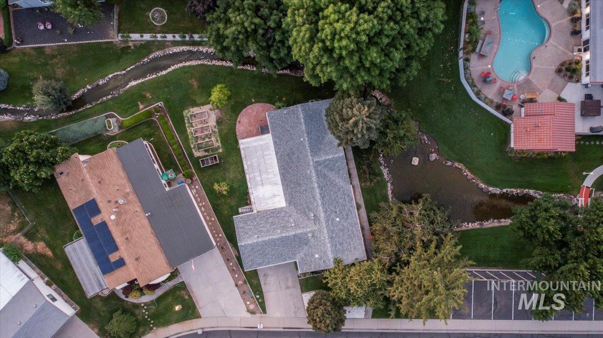 Aerial view of property and surrounding area with a pool area