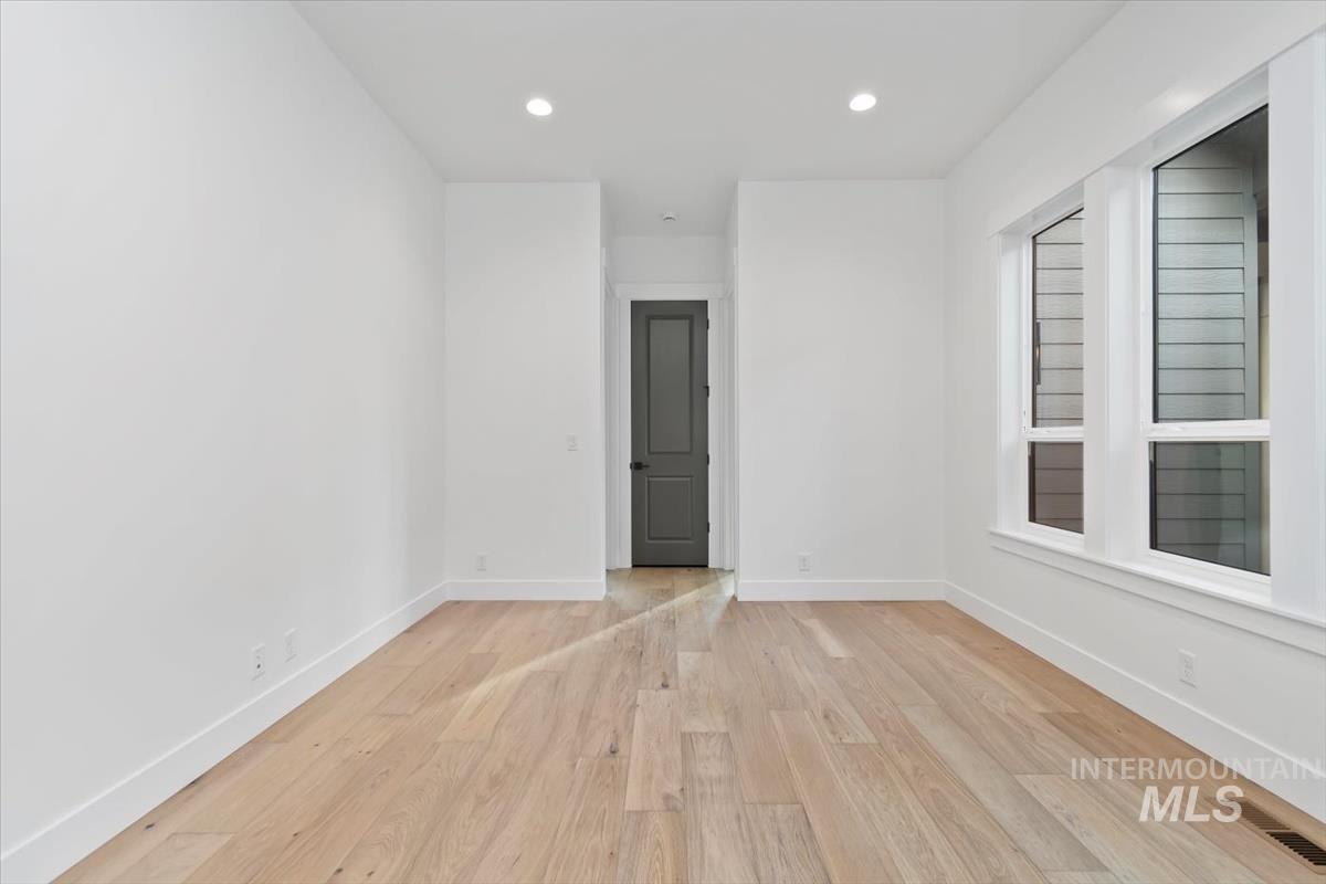 Unfurnished room featuring light wood-style floors and recessed lighting