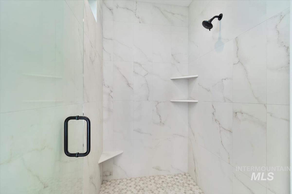 Full bathroom featuring a marble finish shower