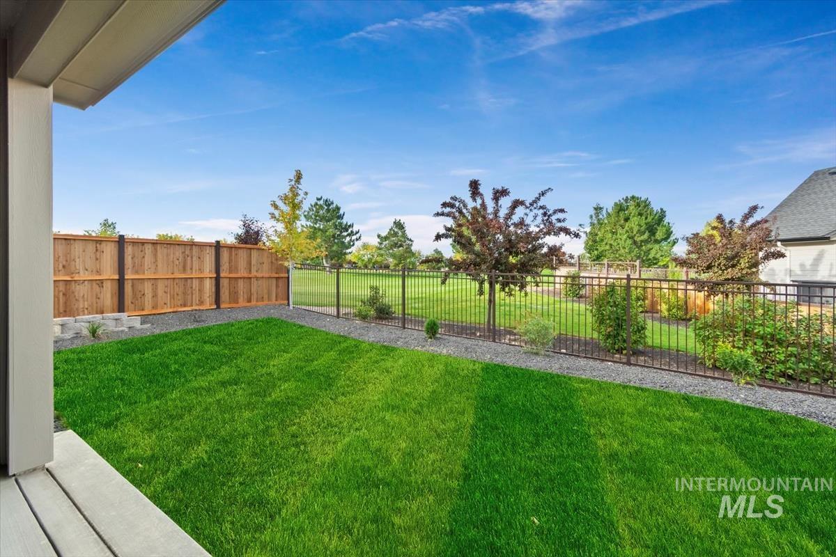 Fenced backyard with a patio
