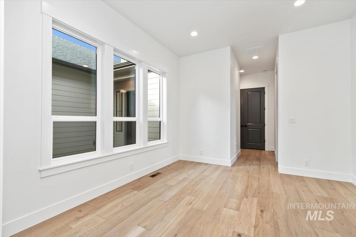 Empty room featuring recessed lighting and light wood-style flooring
