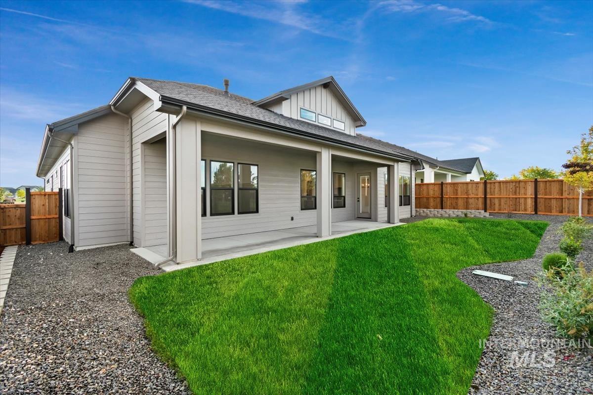 Back of property featuring a patio, a fenced backyard, and a shingled roof