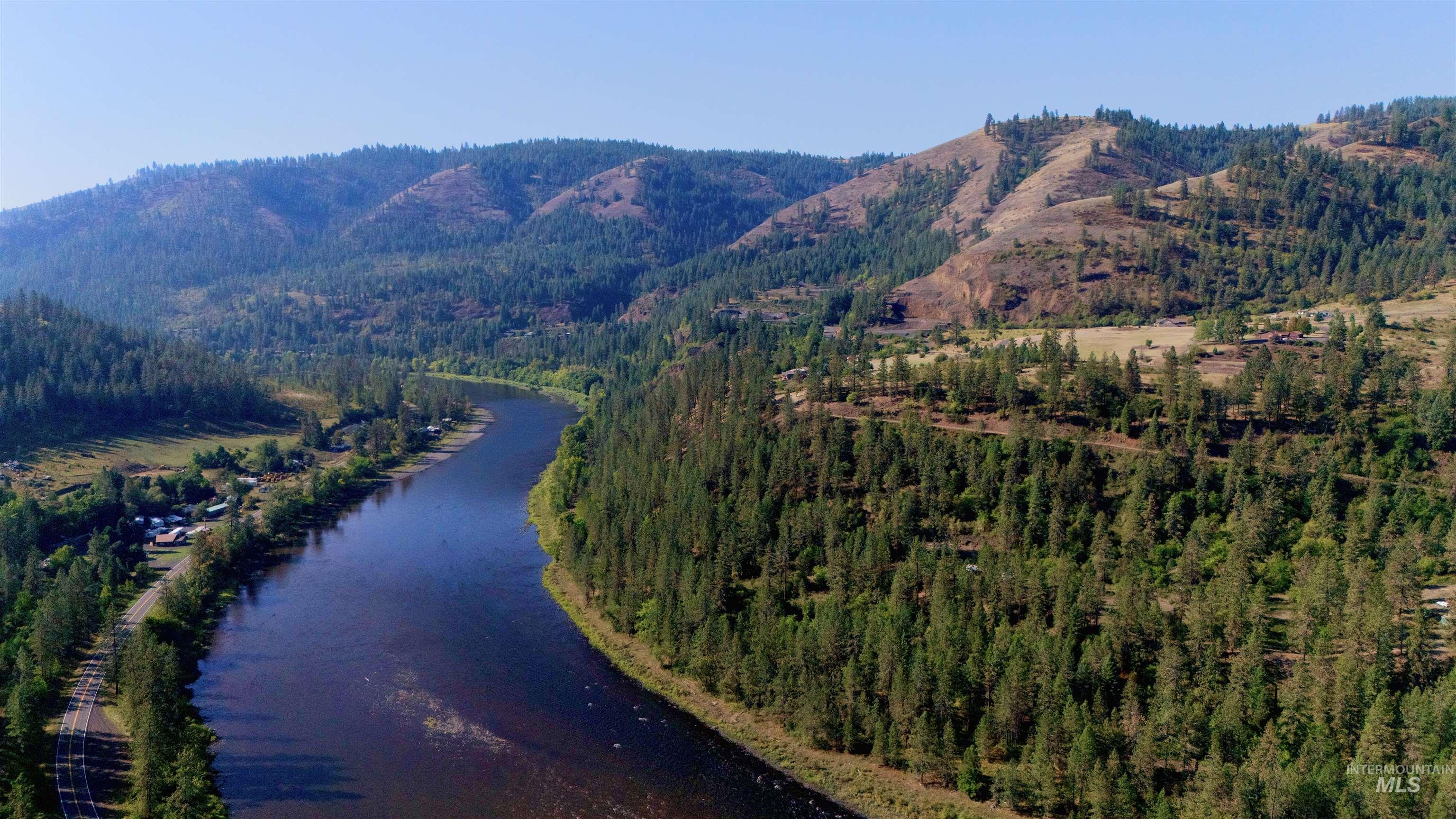 Aerial view of property and surrounding area with a water and mountain view