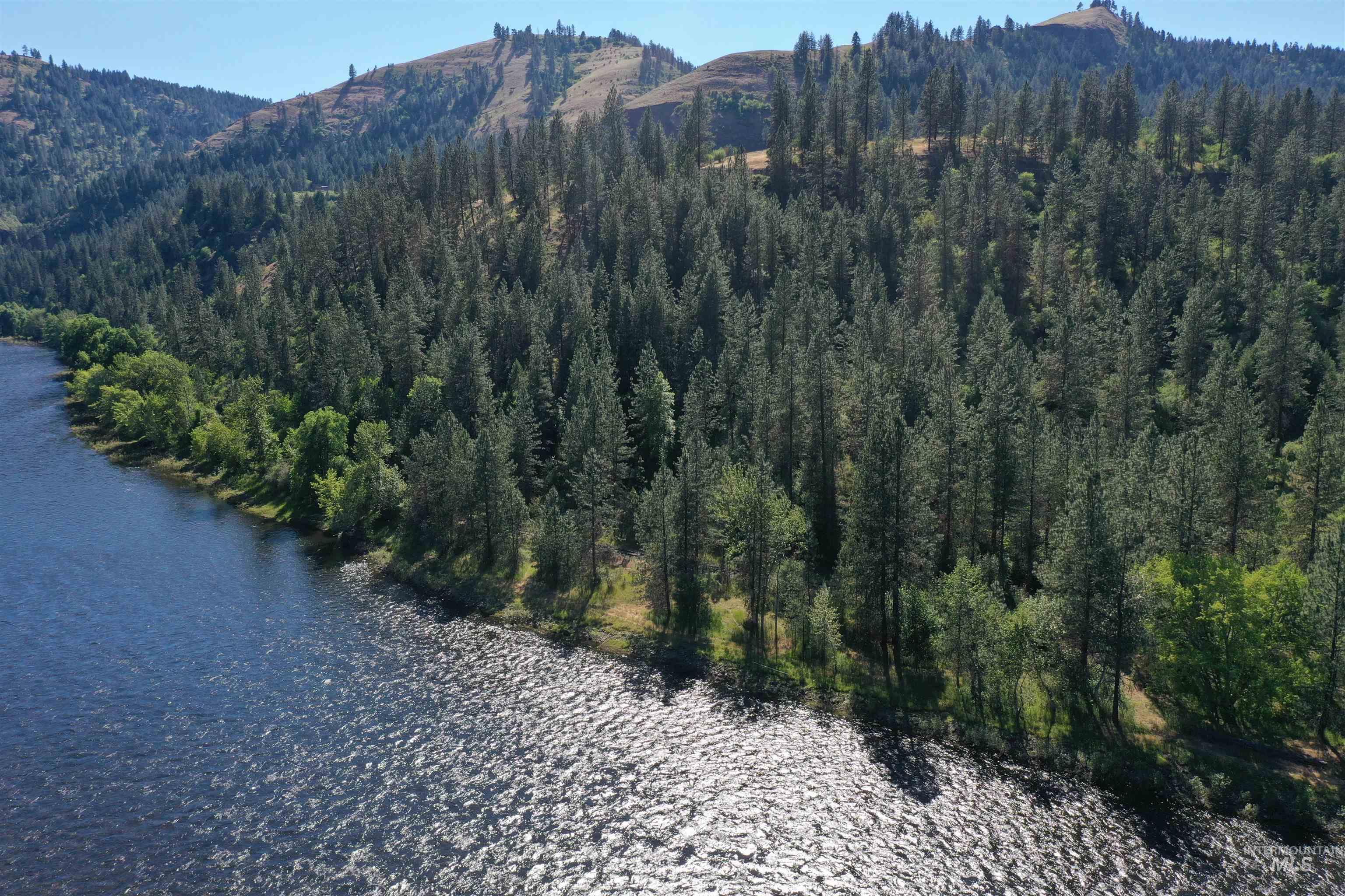 Aerial view of property's location with a water and mountain view