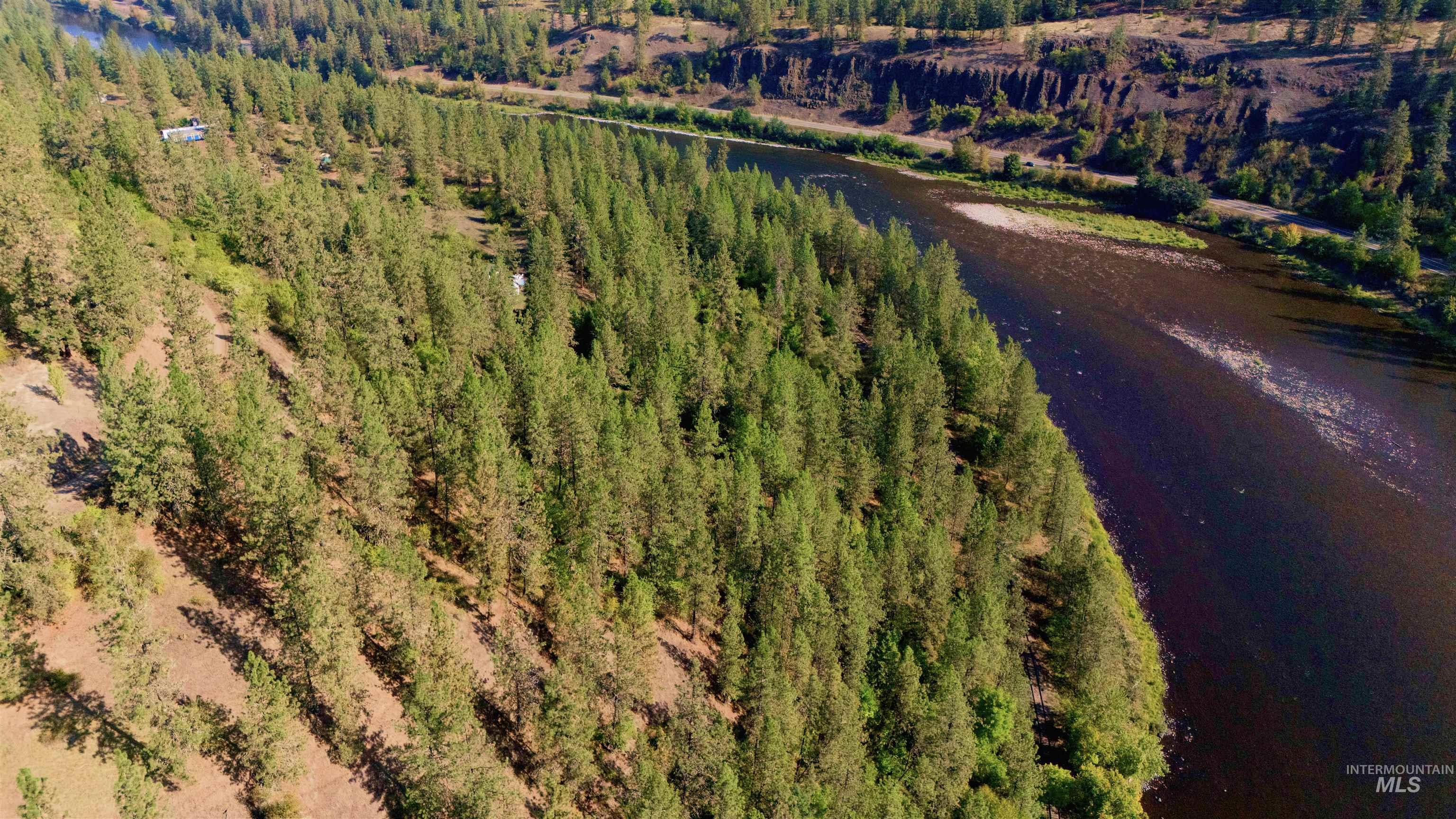 Aerial view of property and surrounding area featuring a nearby body of water