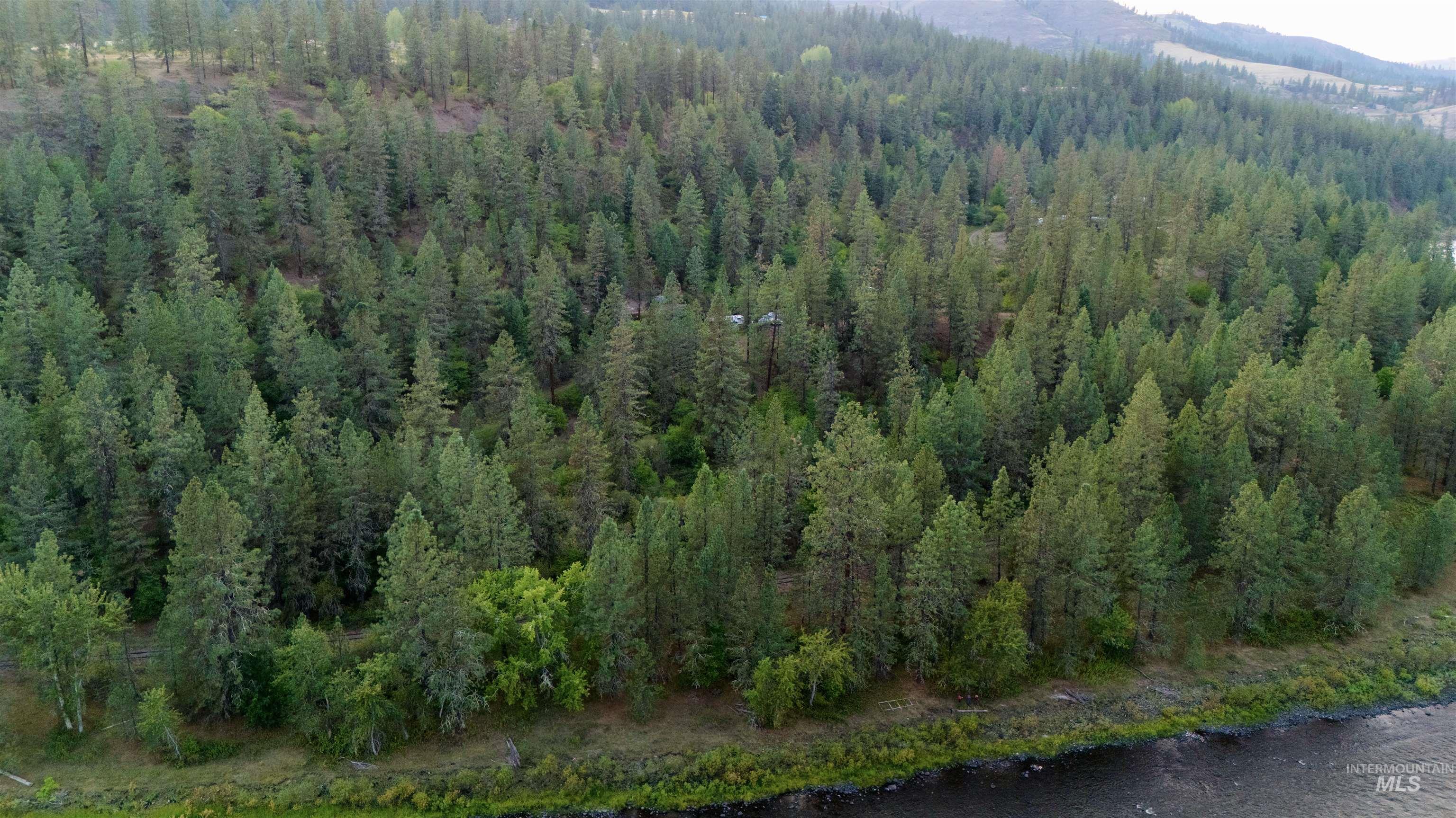 Aerial view of property and surrounding area featuring a large body of water