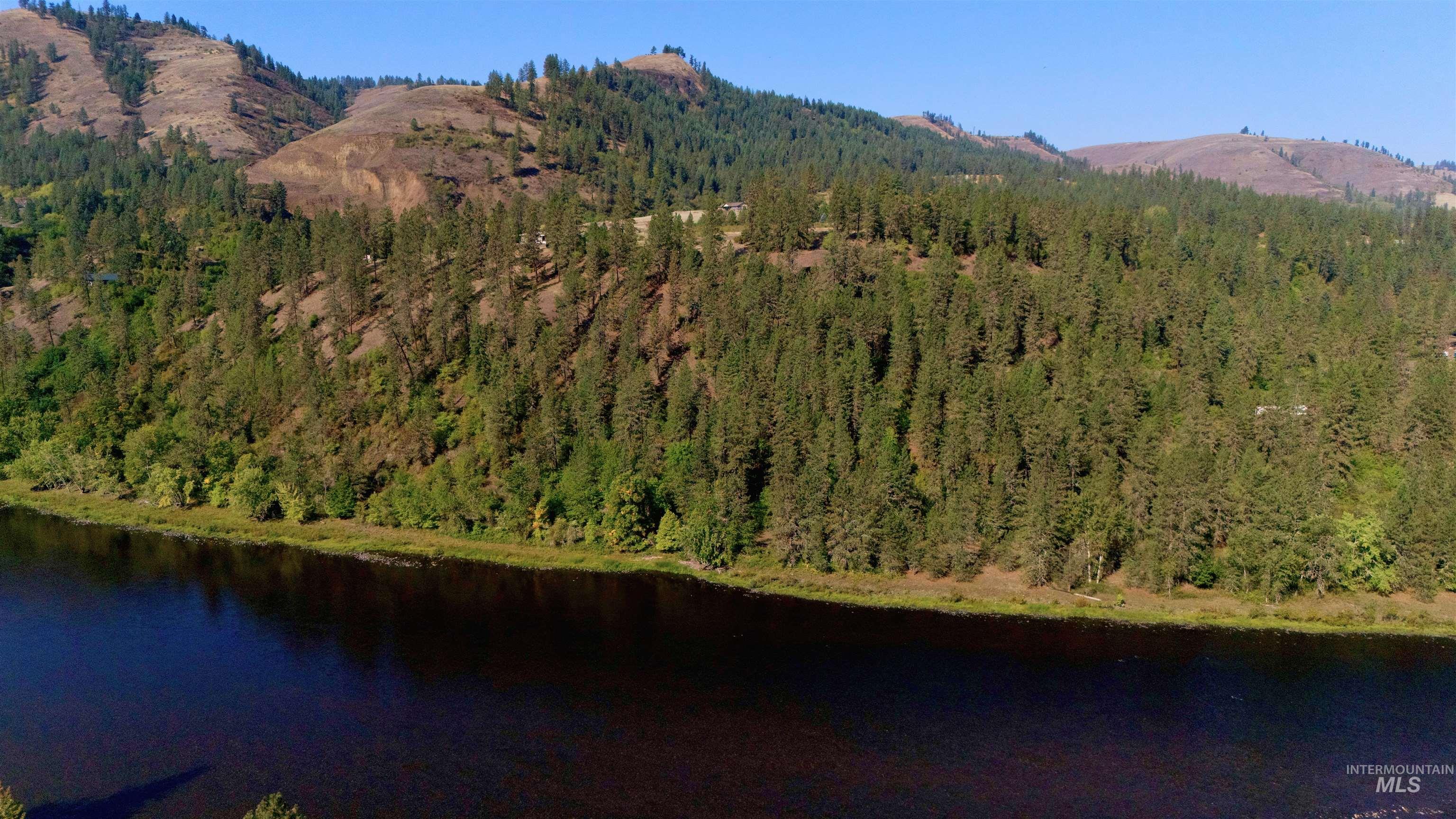 View of mountain backdrop featuring a nearby body of water