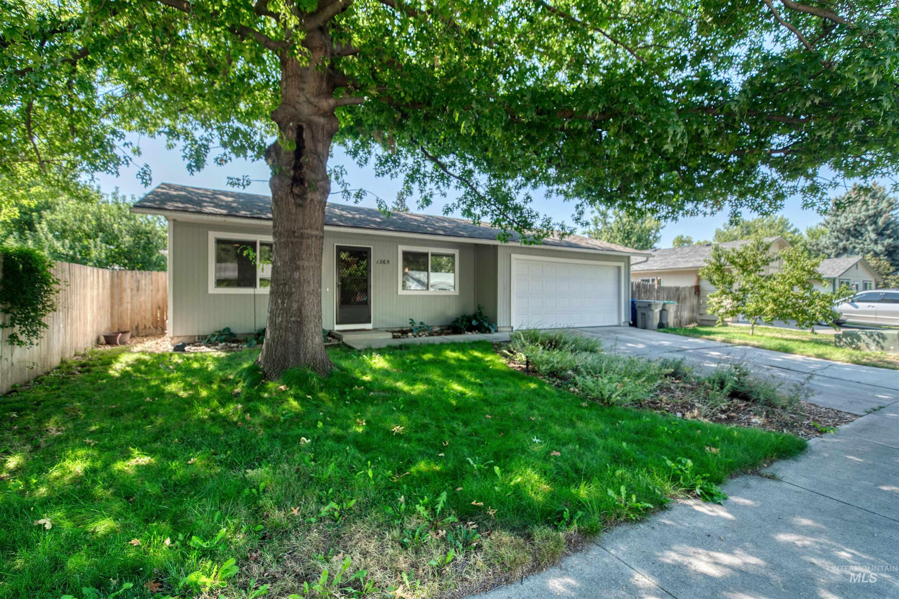 Single story home with driveway, a garage, and a shingled roof