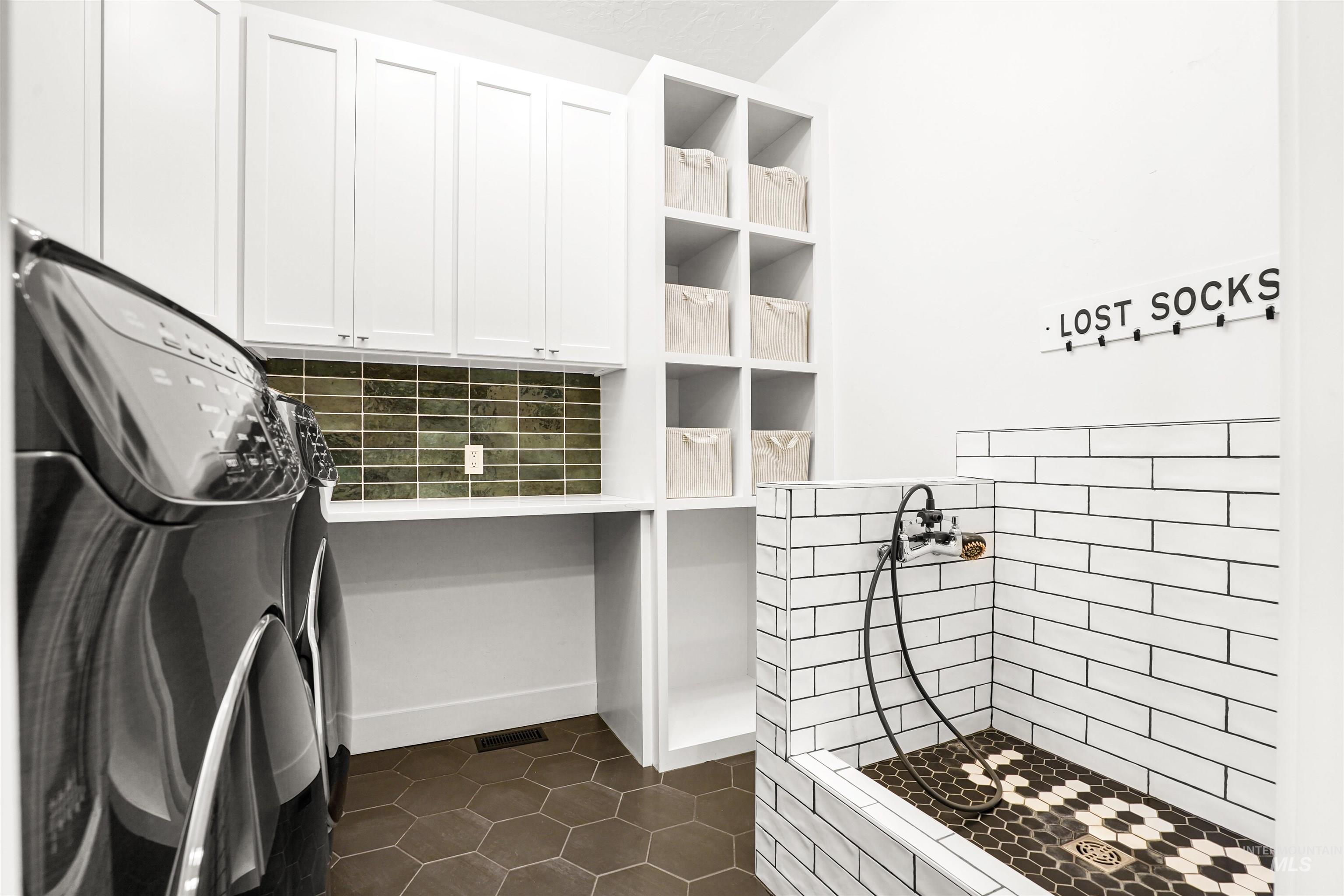 Kitchen featuring dark tile patterned floors, white cabinetry, decorative backsplash, and open shelves