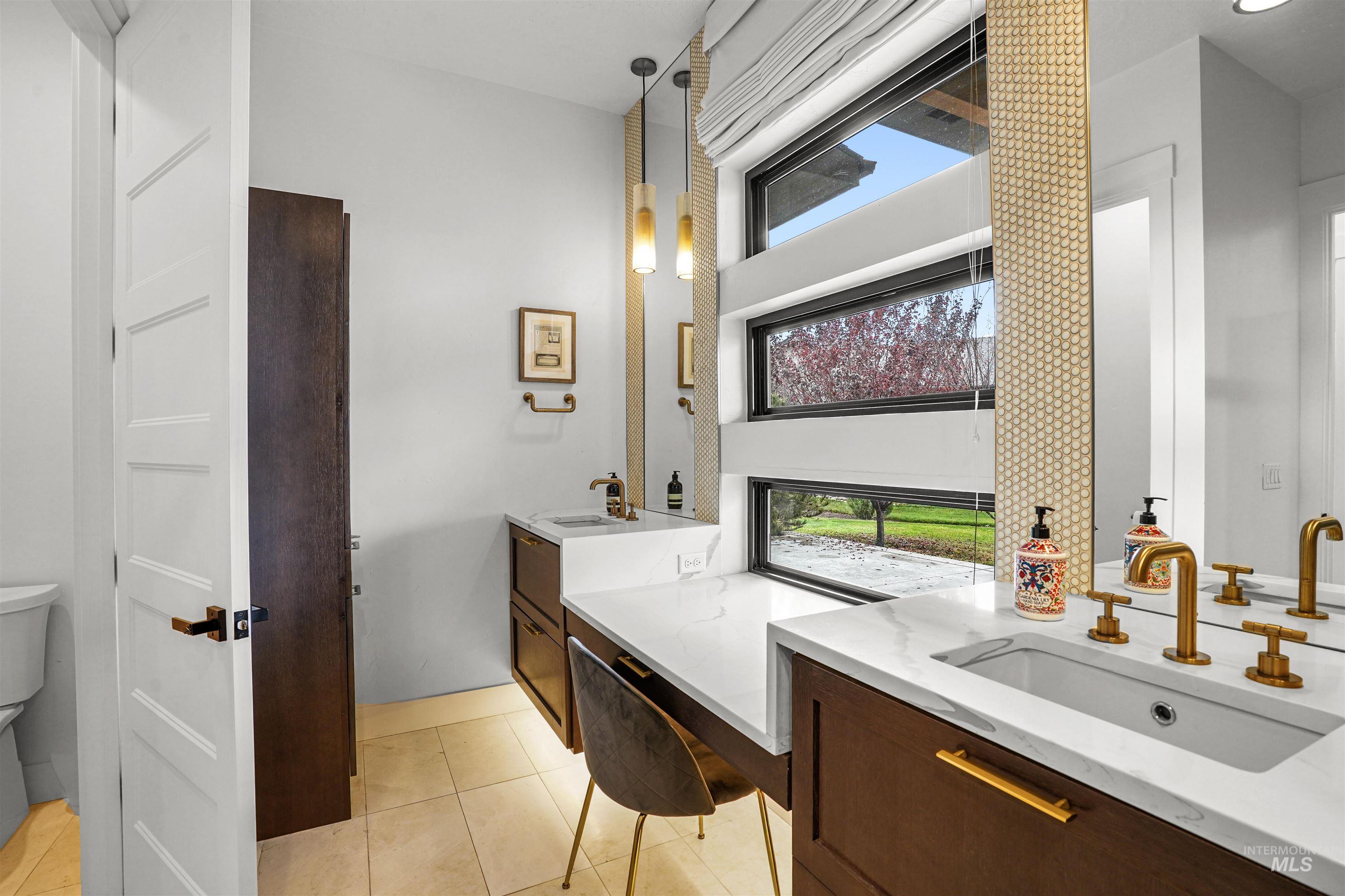 Full bath with two vanities and light tile patterned flooring