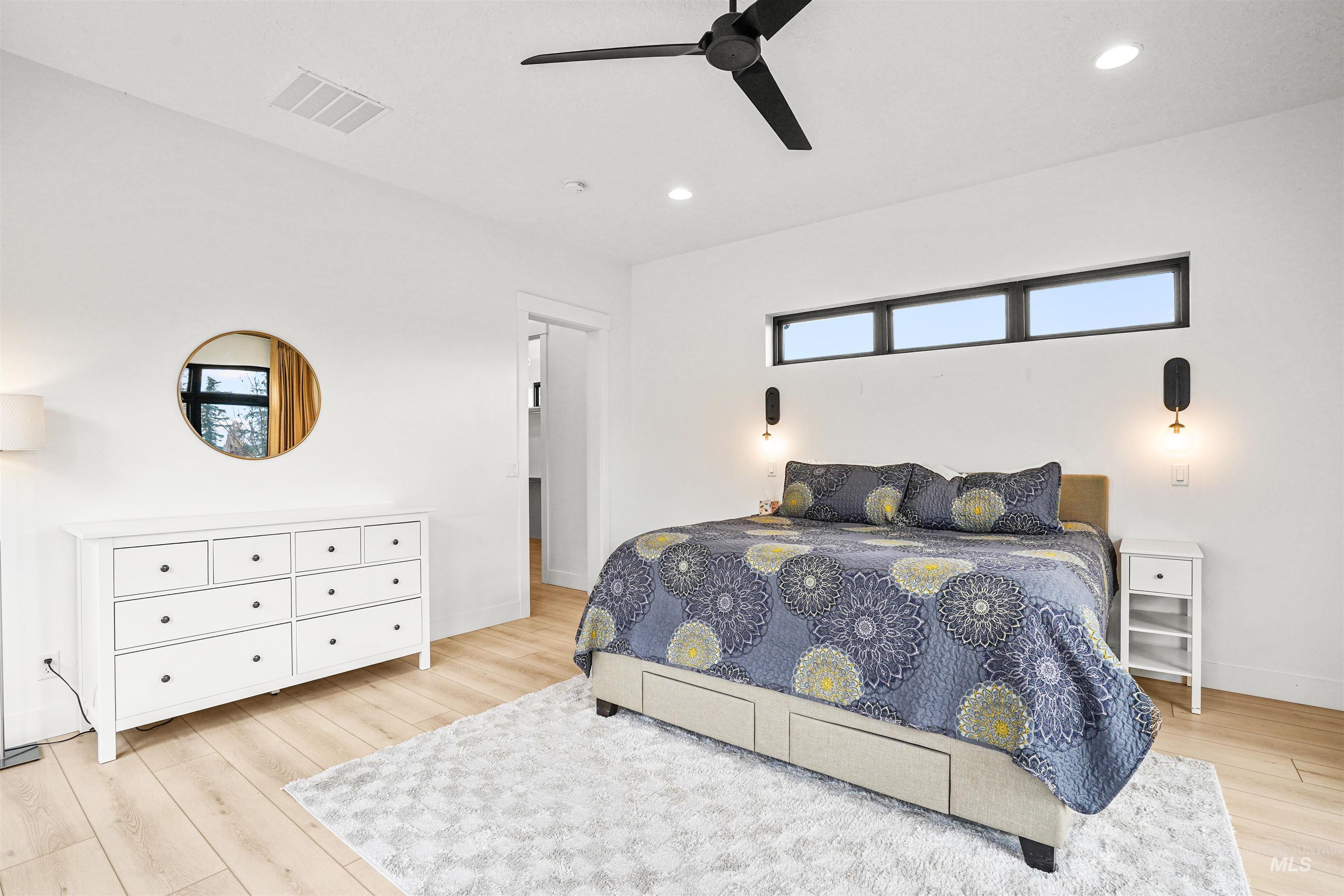 Bedroom featuring light wood-style flooring, ceiling fan, and recessed lighting