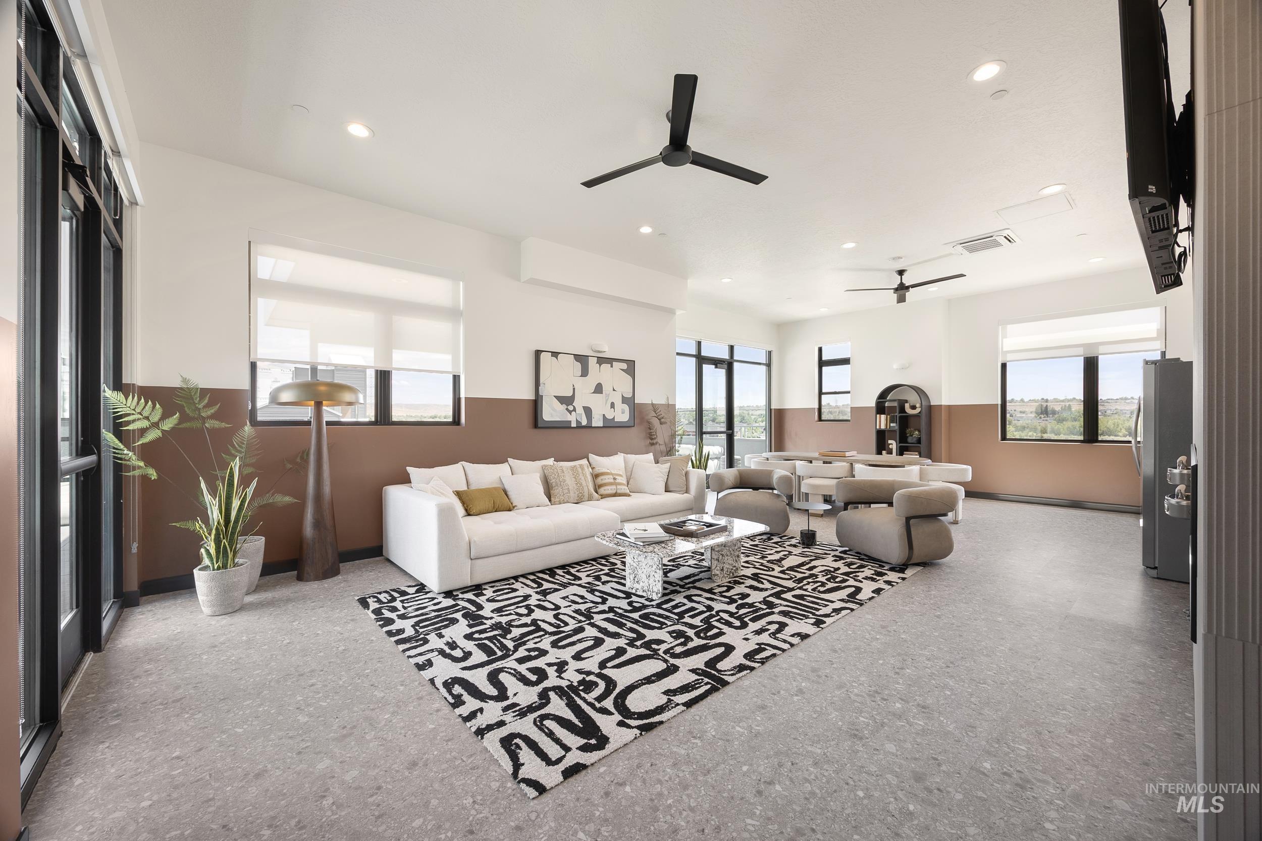 Living room with ceiling fan and recessed lighting