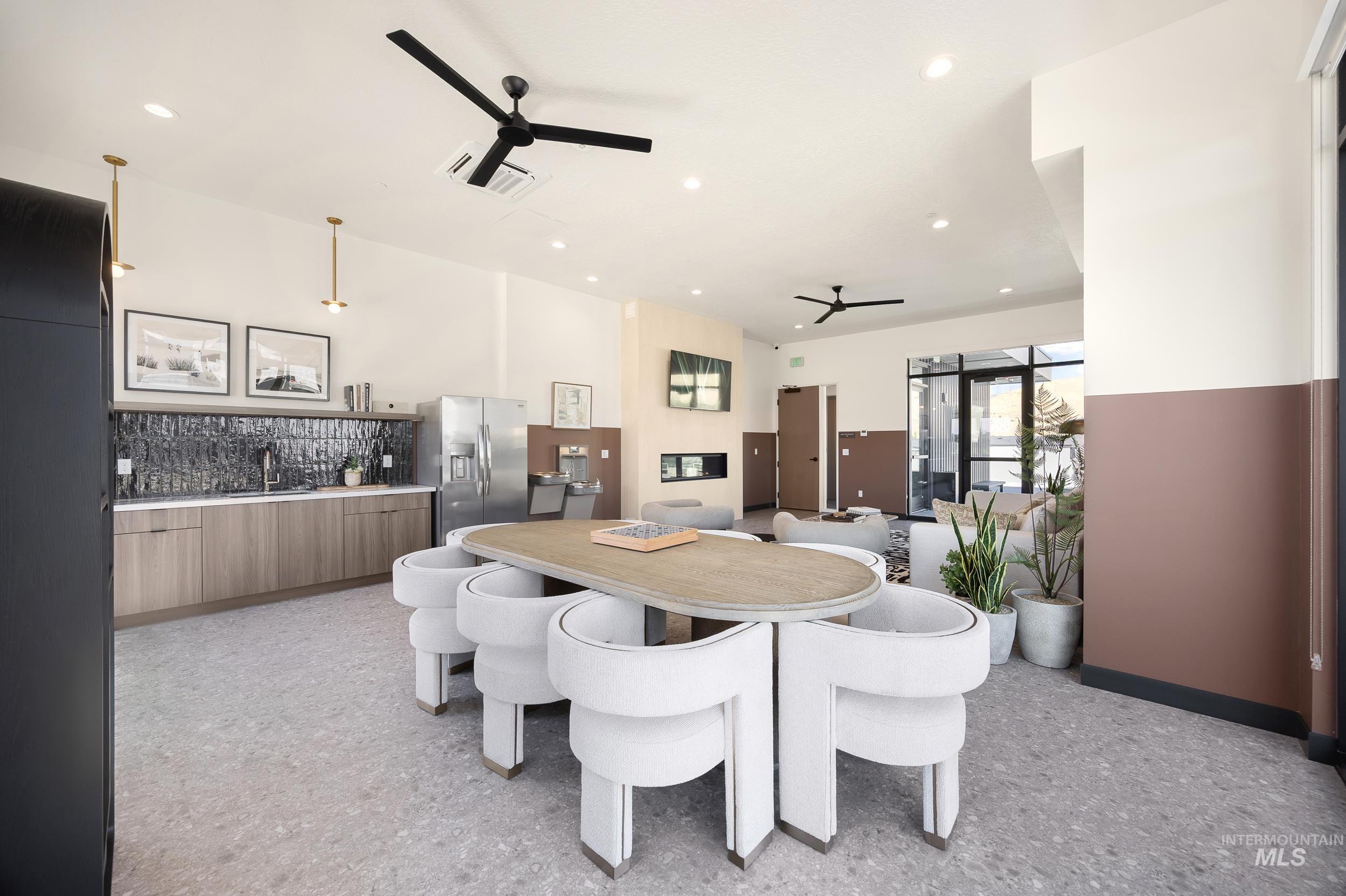 Dining area with a ceiling fan, recessed lighting, and light flooring