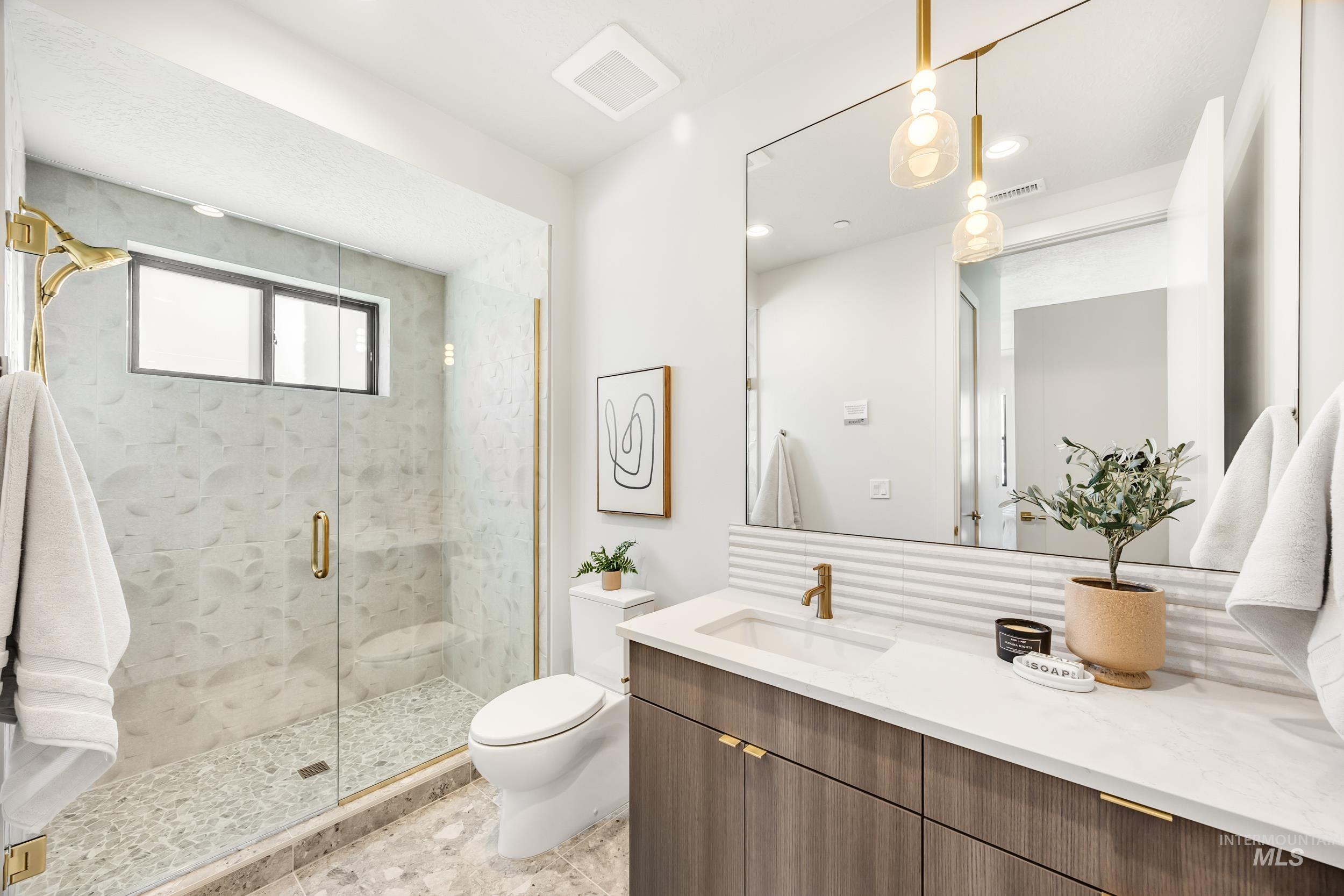 Bathroom featuring a shower stall, vanity, and recessed lighting