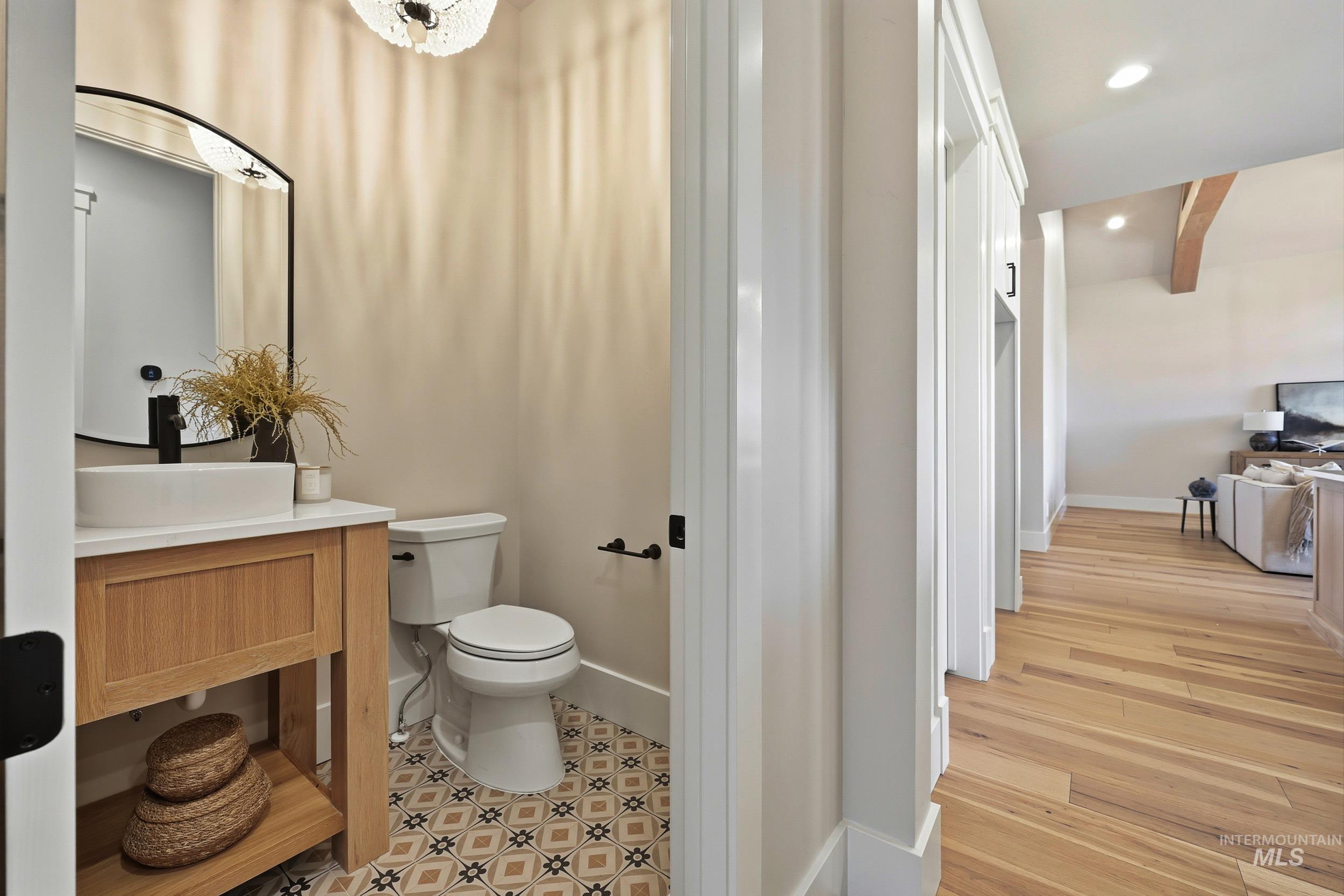Half bath with vanity, recessed lighting, and light wood-type flooring