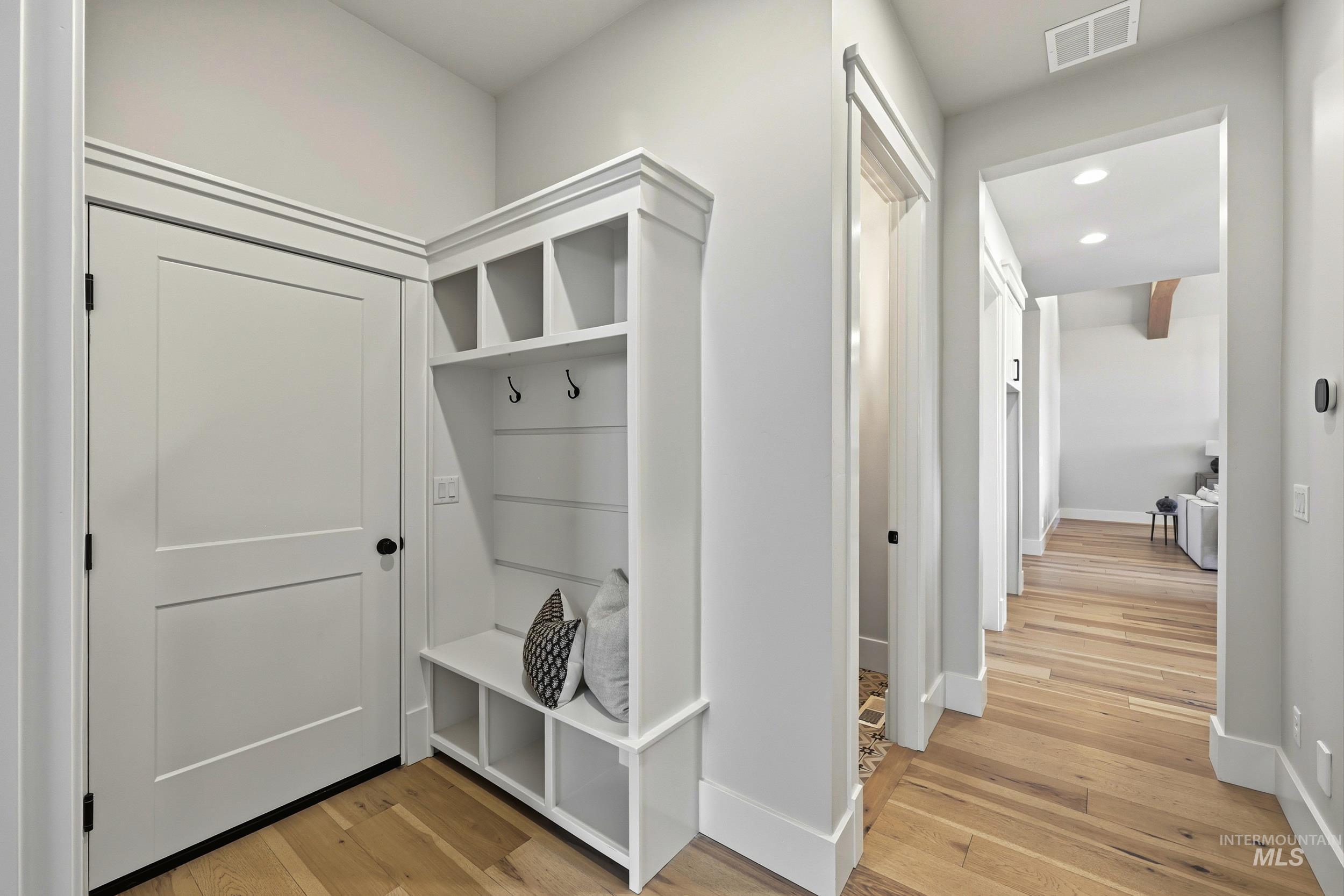 Mudroom featuring light wood finished floors and recessed lighting