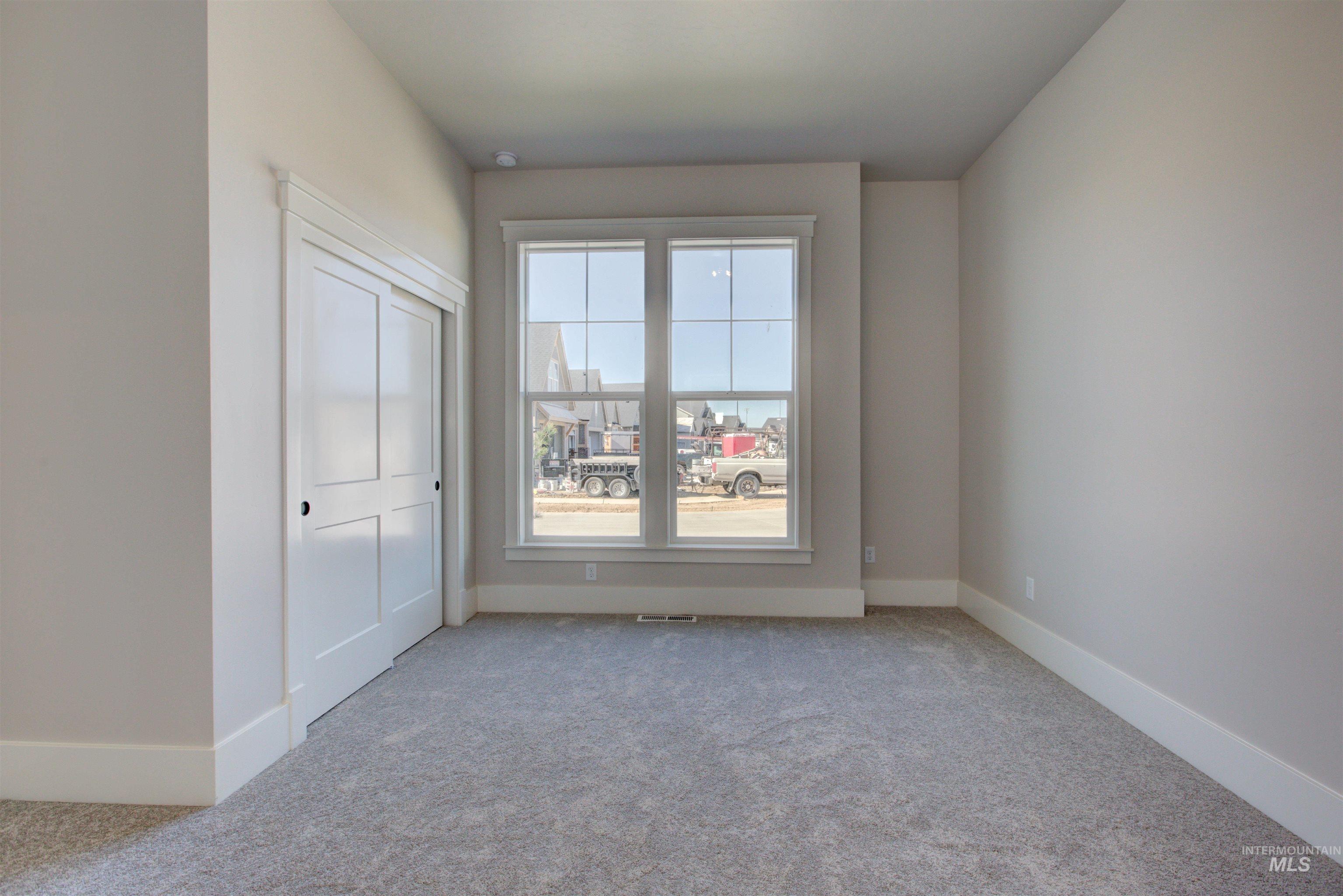Unfurnished room with carpet and baseboards