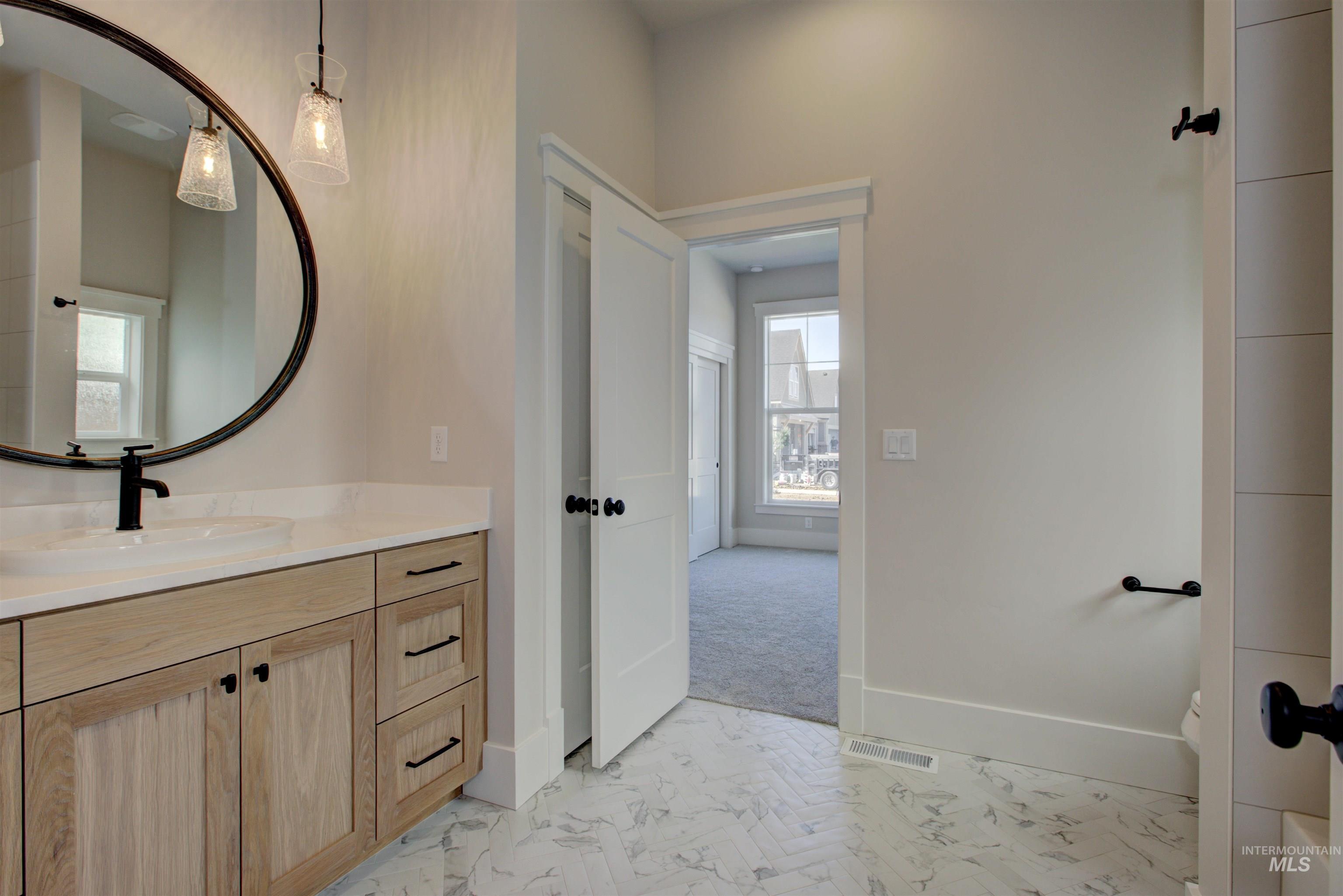 Bathroom with vanity and baseboards