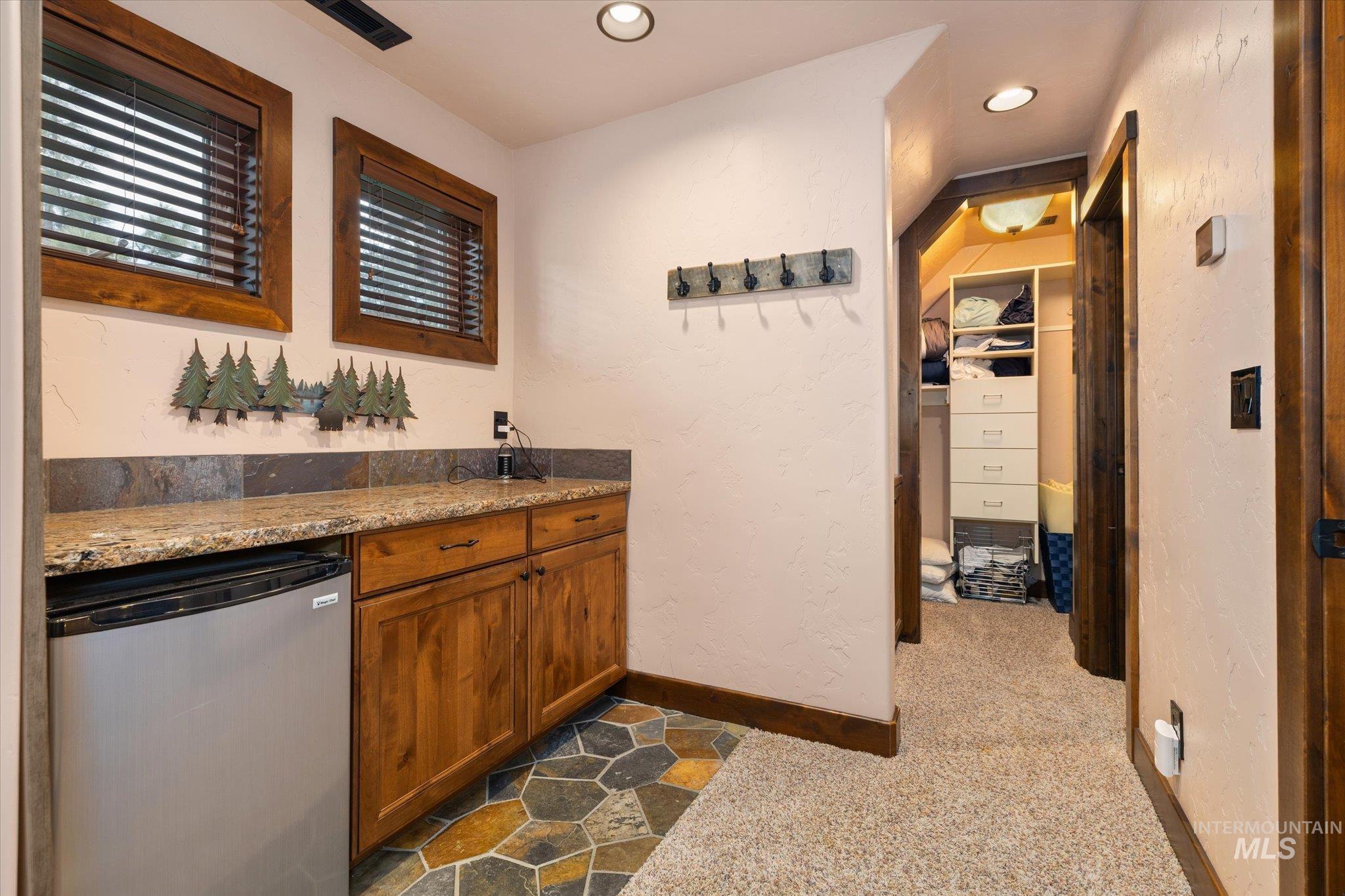Built-in cabinetry with granite-style countertops and a tile backsplash