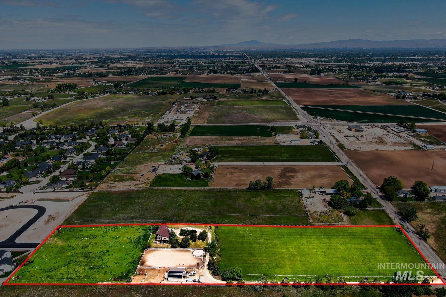 Aerial view of property's location featuring property parcel outlined and a mountain backdrop